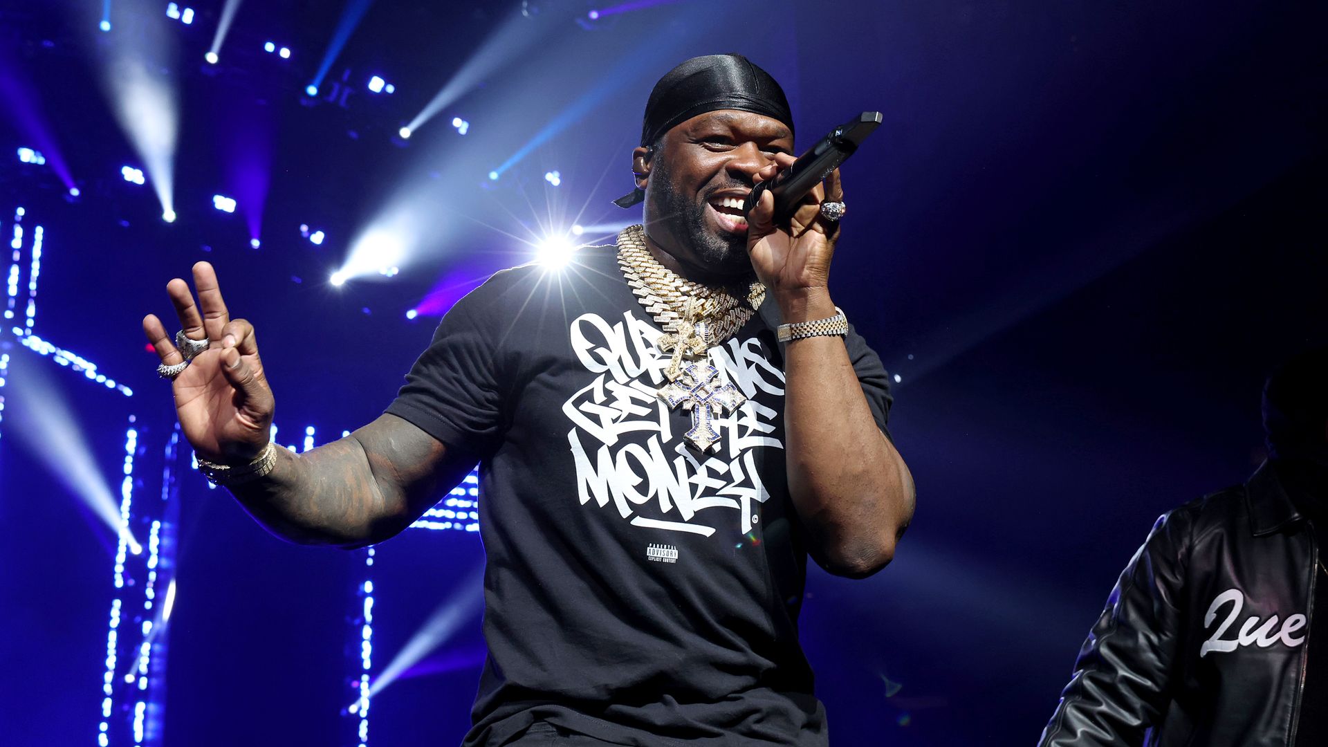 Photo shows 50 Cent rapping on stage with a microphone