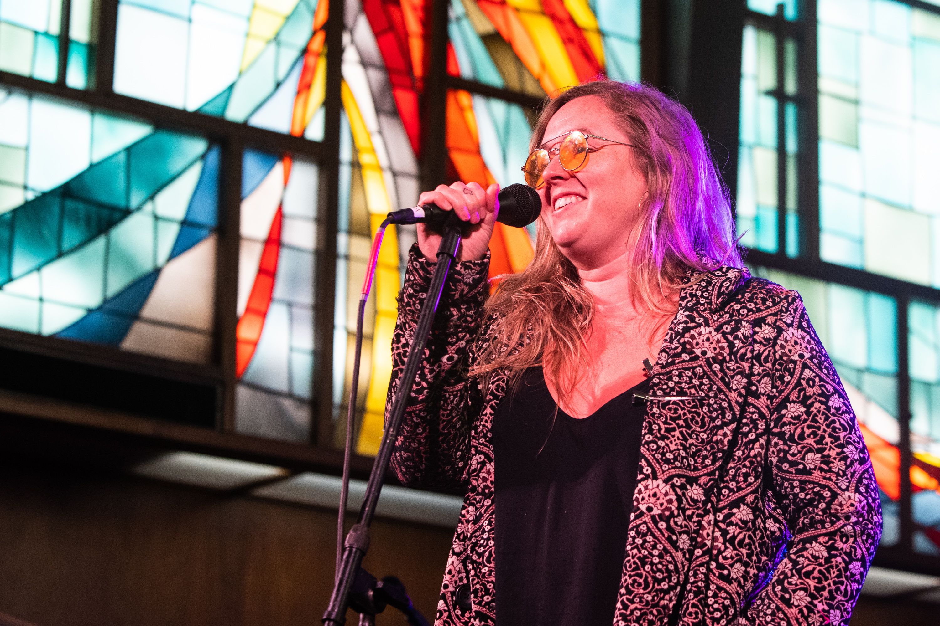 A photo of Sir Woman singing into a mic.