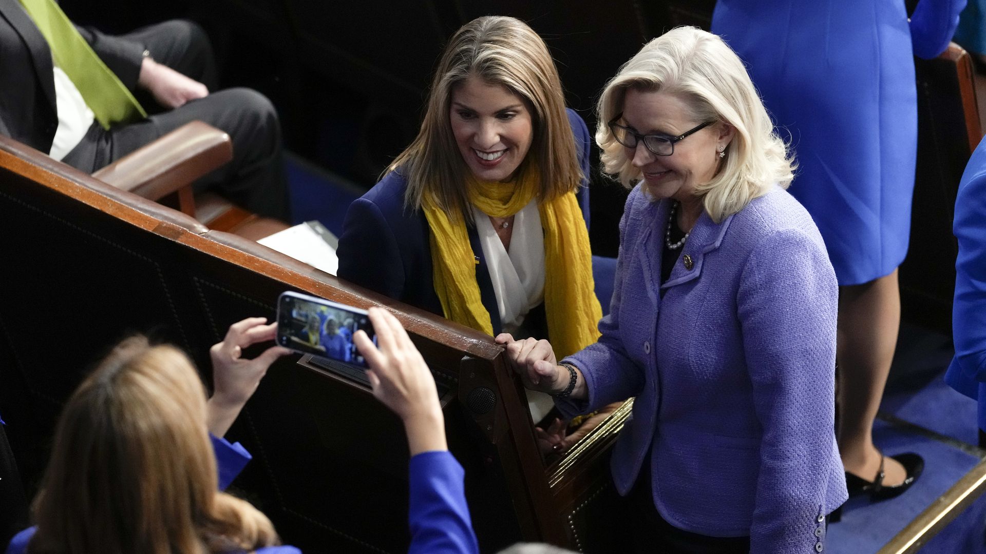 Then-Rep. Liz Cheney (R-Wyo.) poses for a photo before Ukrainian President Volodymyr Zelensky addresses a joint session of Congress, in the House chamber on Dec. 21.