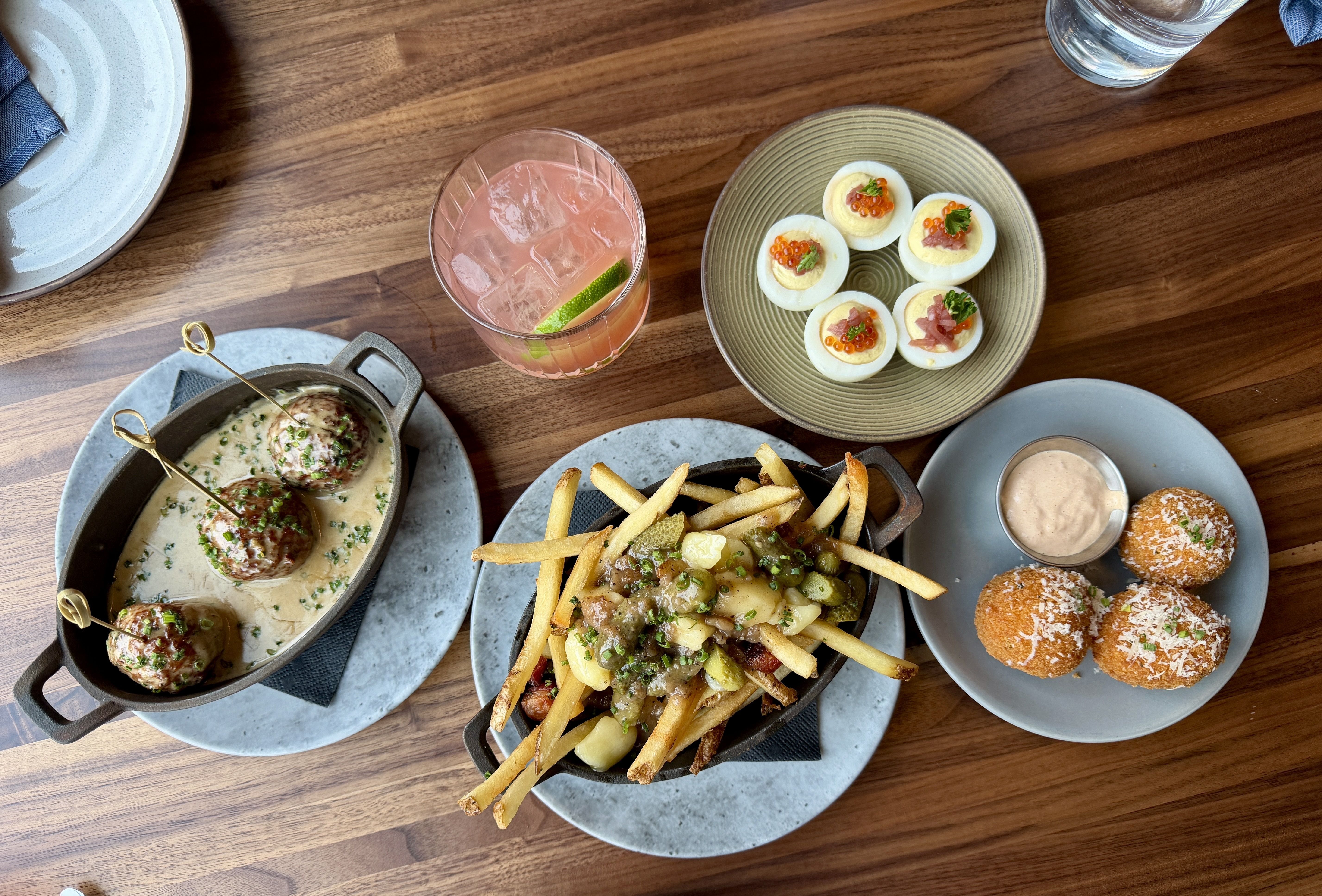 Snacks on a table with a cocktail