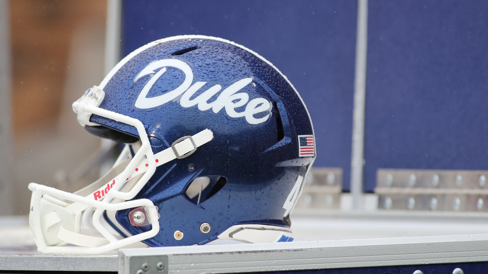 A Duke football helmet sits alone, covered in rain drops. 
