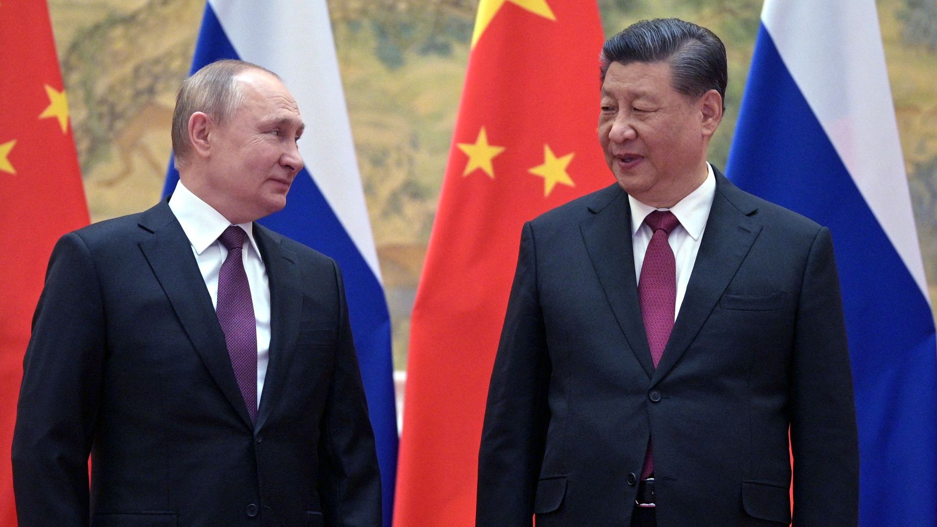 Russian President Vladimir Putin (L) and Chinese President Xi Jinping pose for a photograph during their meeting in Beijing, on February 4.