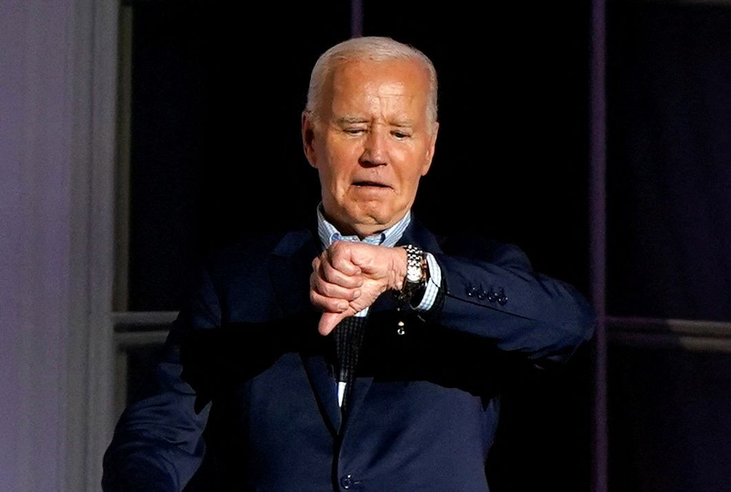 U.S. President Joe Biden looks at his watch 