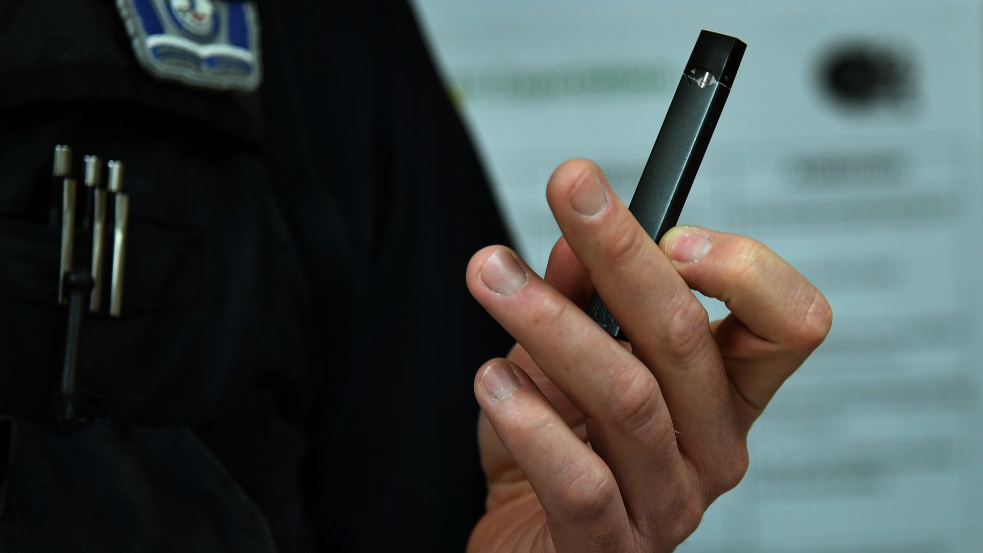 Man holding a juul e cigarette