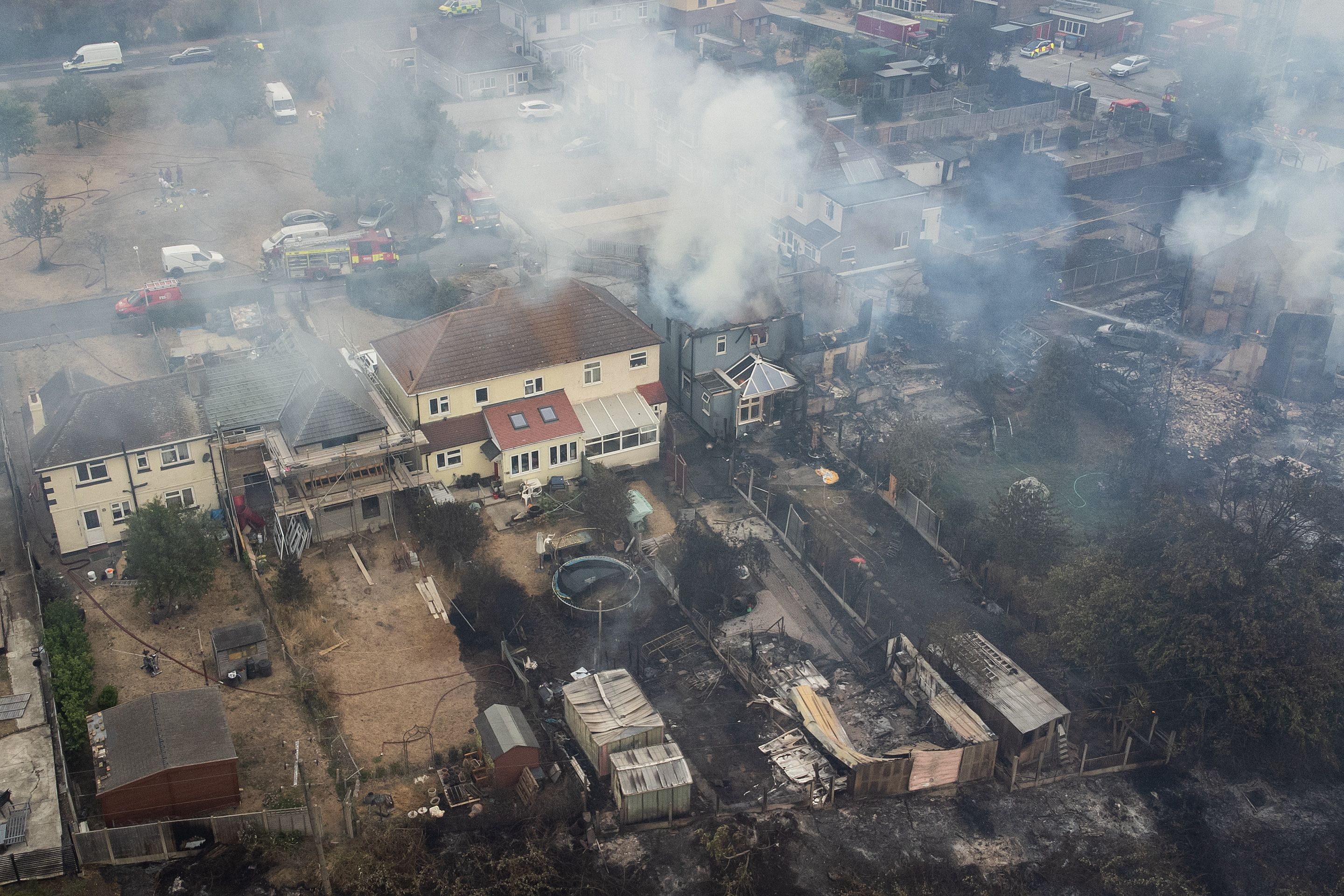 Burned buildings and smoke from a fire in a residential area in Wennington, England, on July 19.