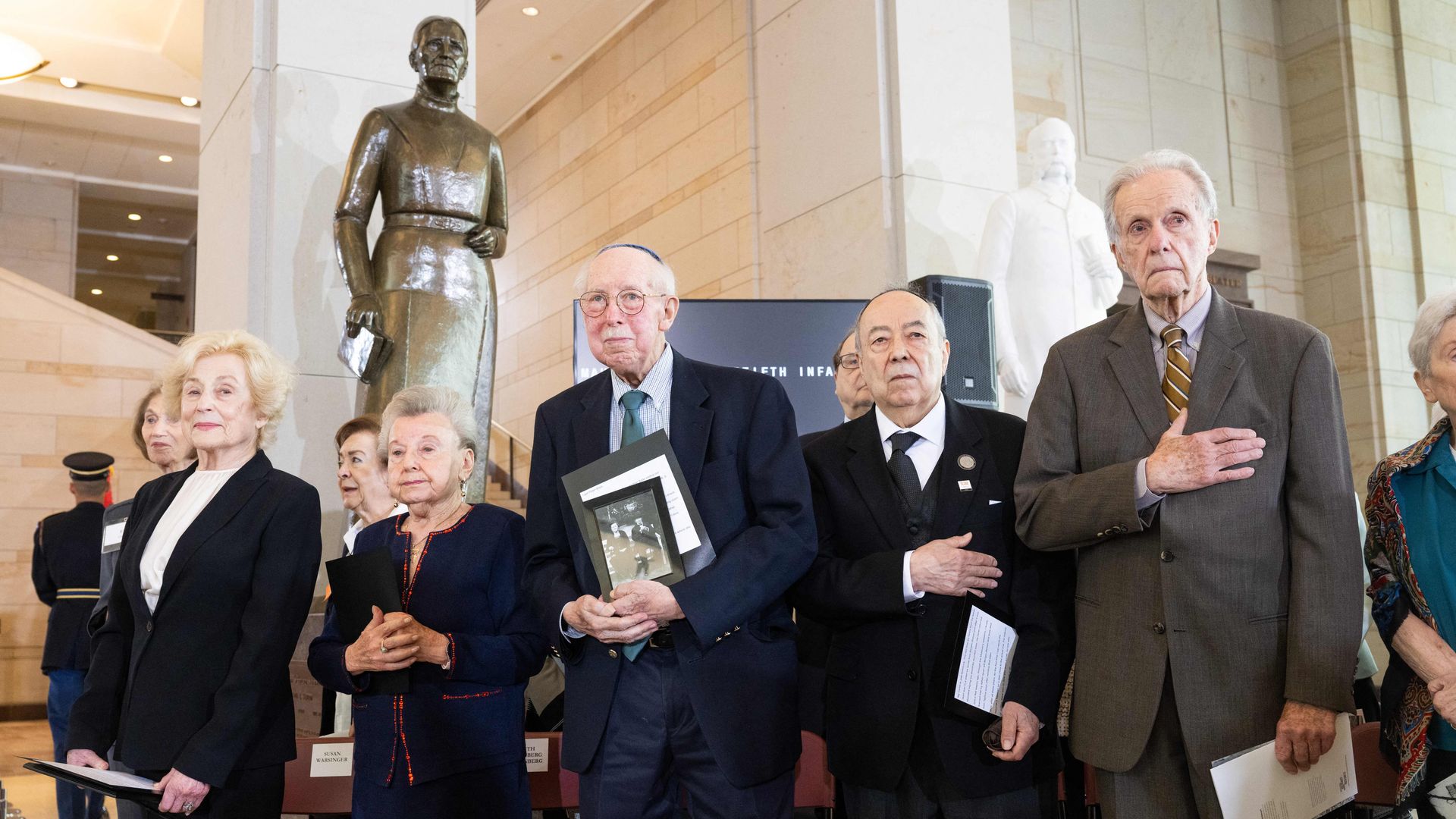 Holocaust survivors stand during the 2023 Days of Remembrance commemoration hosted by the US Holocaust Memorial Museum on Capitol Hill in Washington, DC, April 20, 2023. 