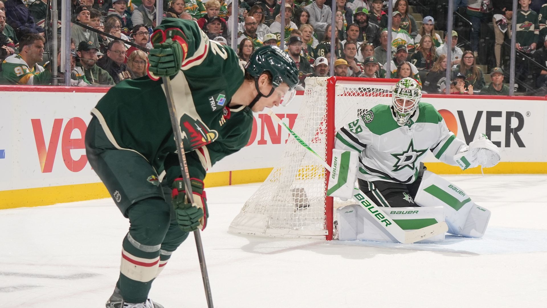 Matt Boldy aims for the net being guarded by Jake Oettinger 