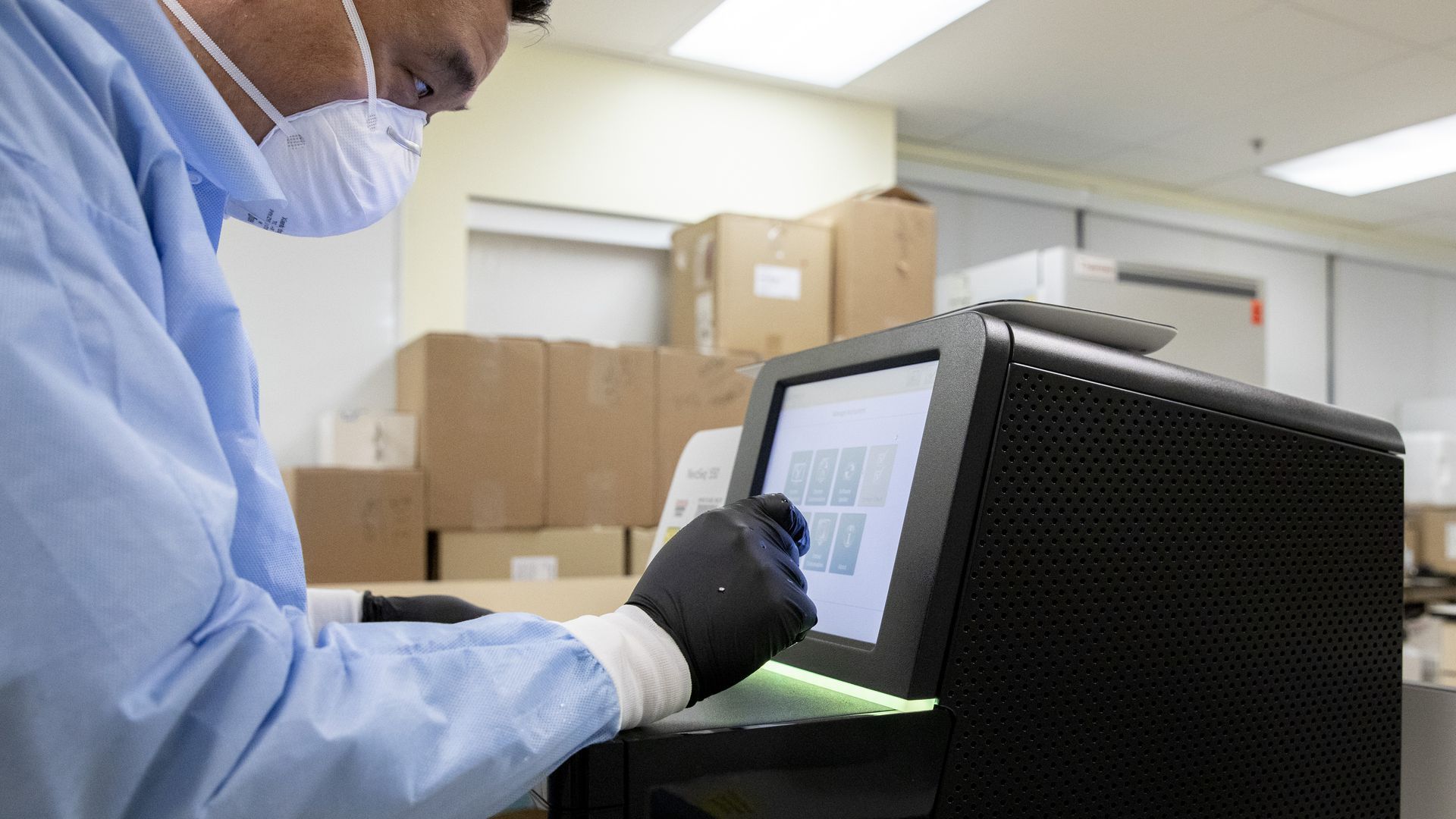 A researcher in San Francisco uses the Illumina NextSeq 550 genetic sequencer to decode a COVID-19 infection.