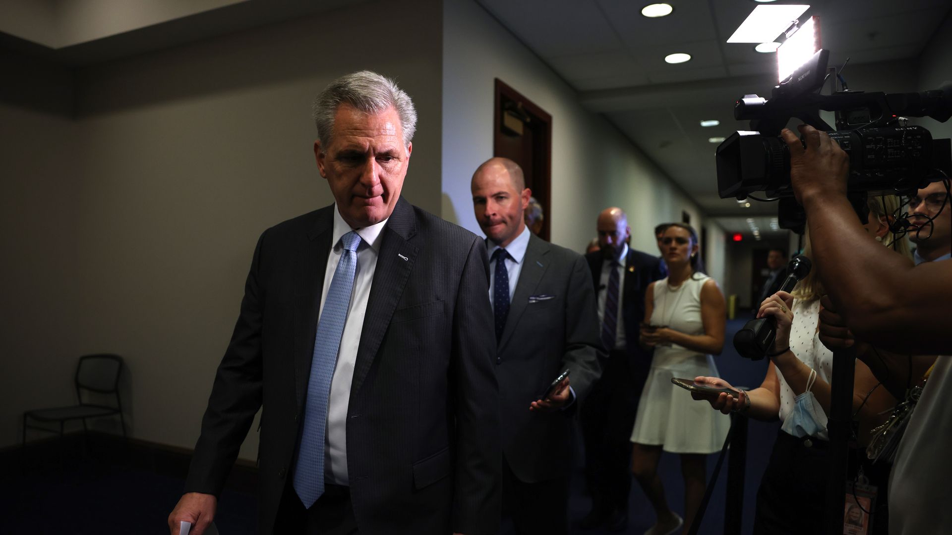 Photo of Kevin McCarthy speaking to reporters in a hallway