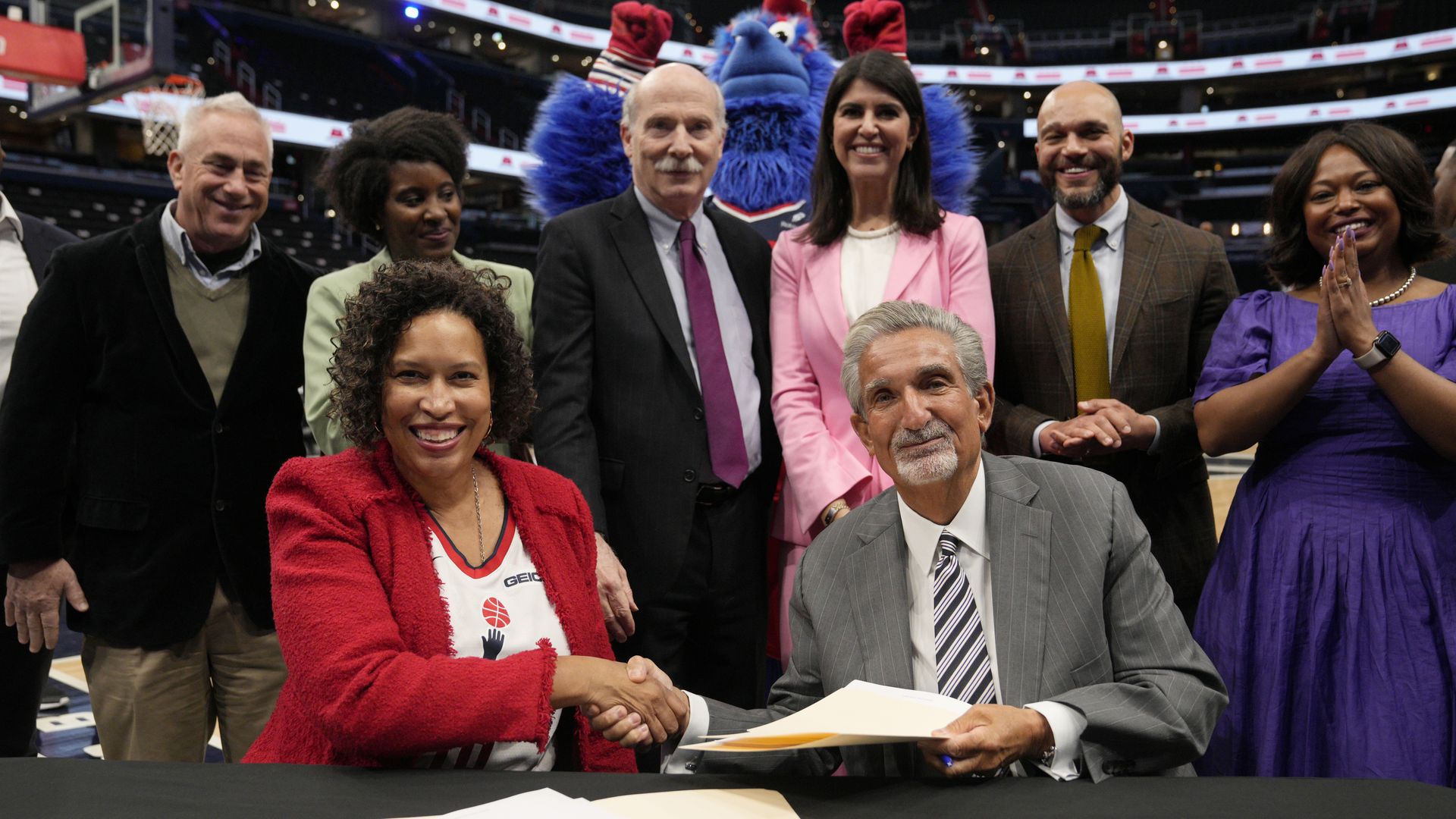 Muriel Bowser and Ted Leonsis shake hands