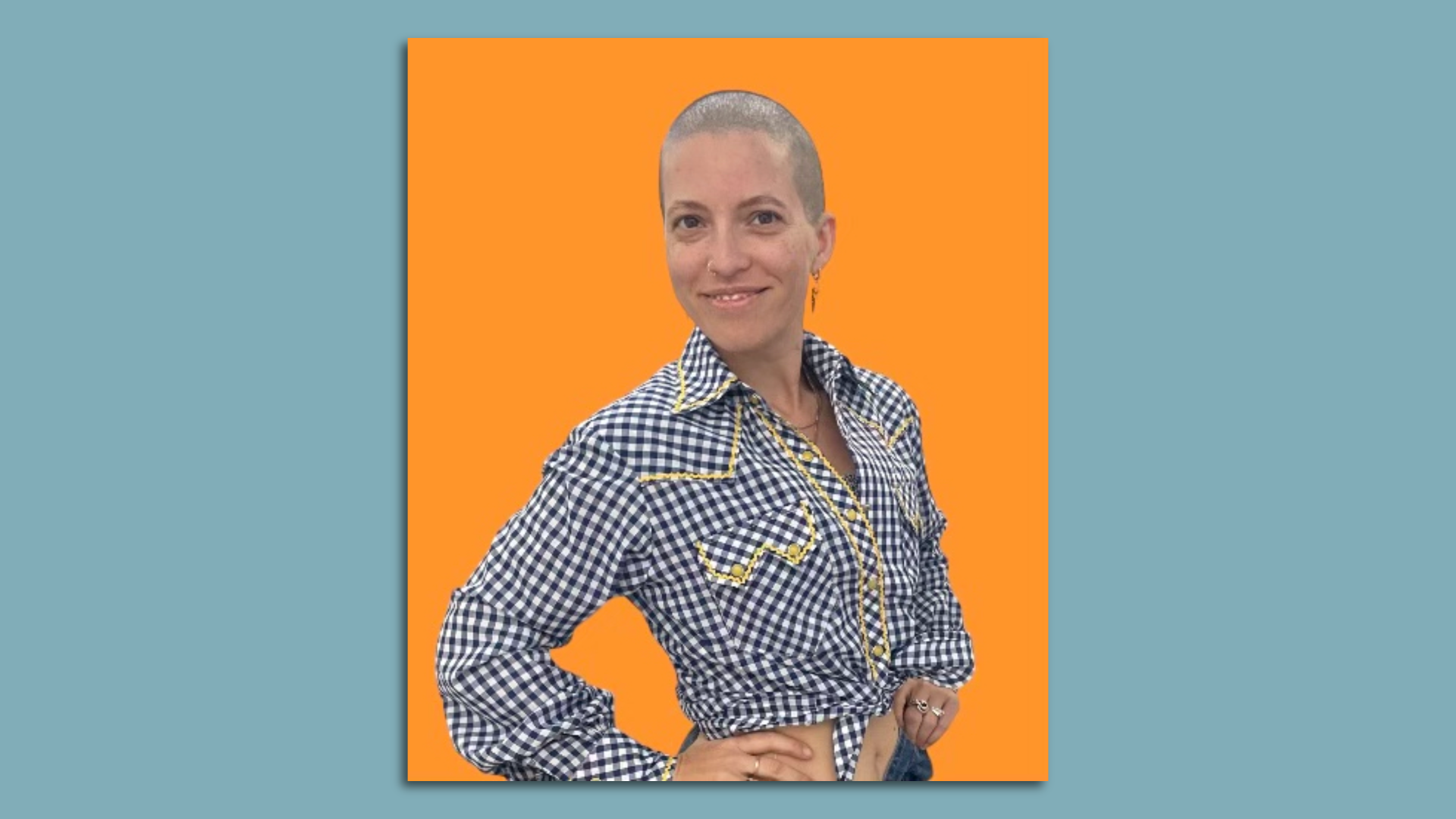 Sigourney Morrison poses for a headshot wearing a gingham shirt against an orange background.
