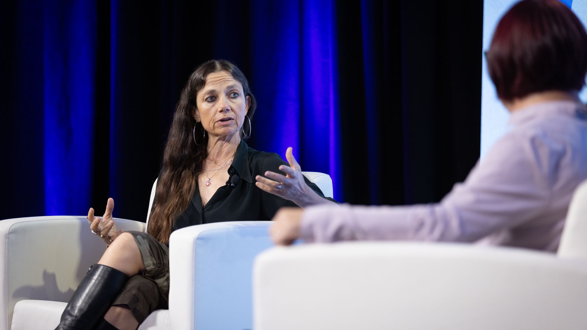 Justine Bateman speaking on stage with Ina Fried