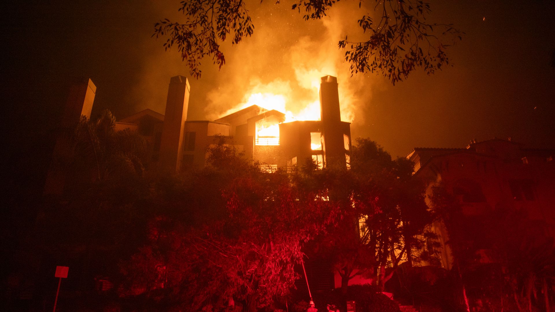 Flames from the Palisades Fire burn a residential building on Sunset Boulevard amid a powerful windstorm on January 9, 2025 in the Pacific Palisades neighborhood of Los Angeles, California. Multiple wildfires fueled by intense Santa Ana Winds are burning across Los Angeles County. 