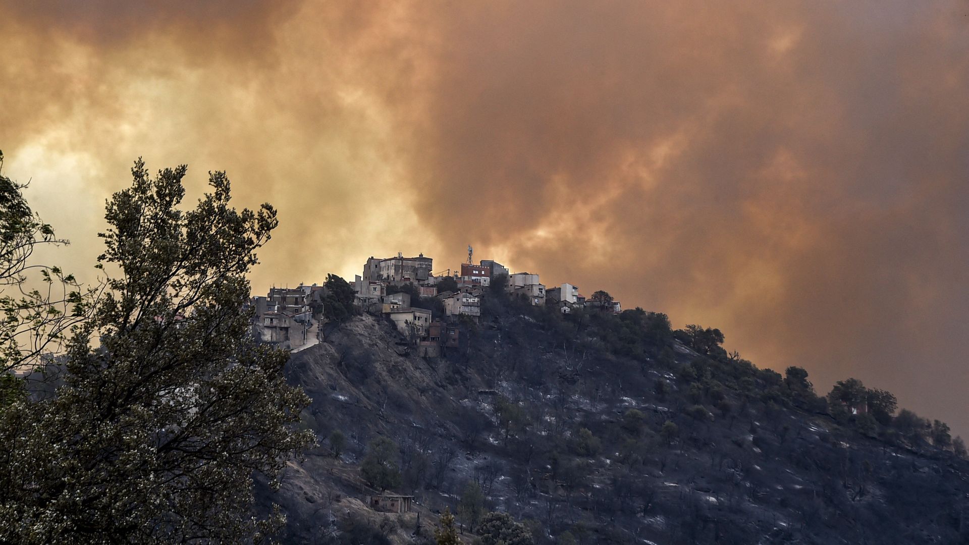 Smoke rises from a hilltop