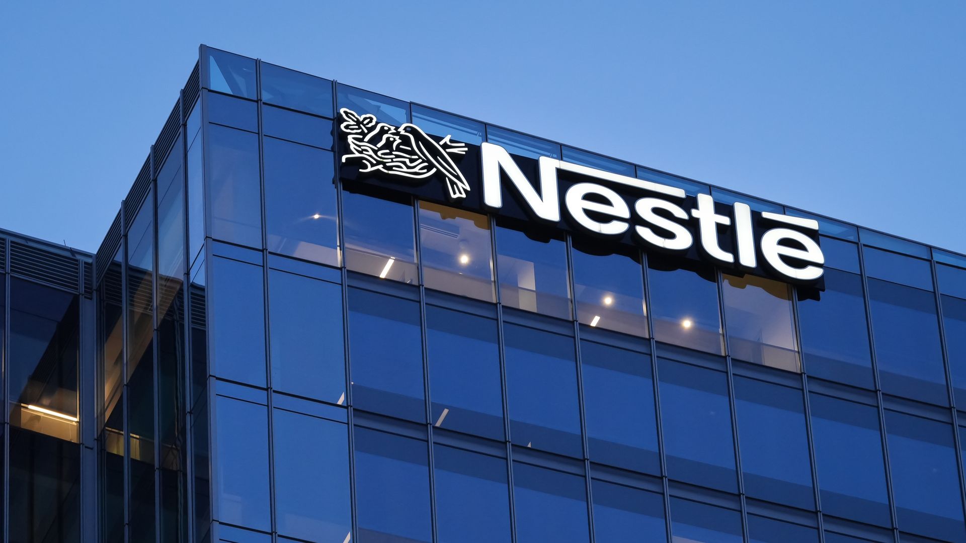 Glass building exterior with white Nestlé wordmark near top.