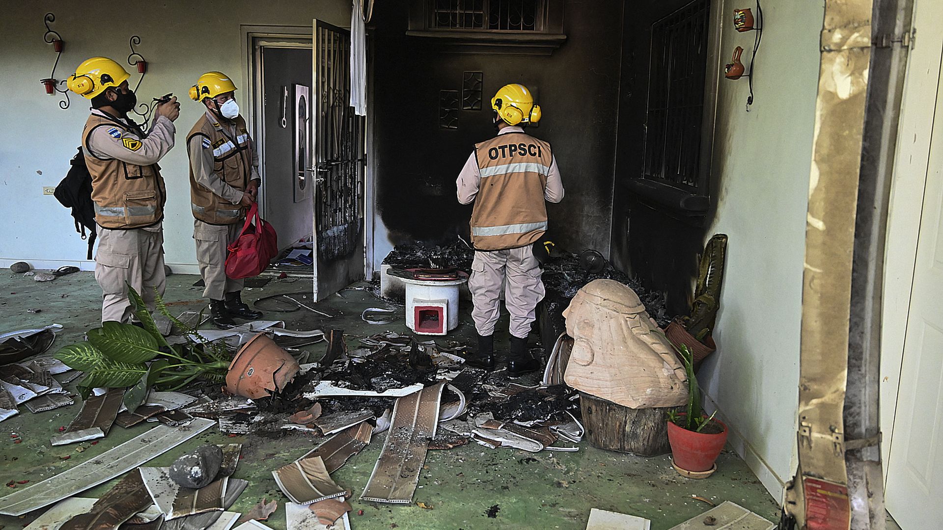 Picture of Honduran police in a burned house