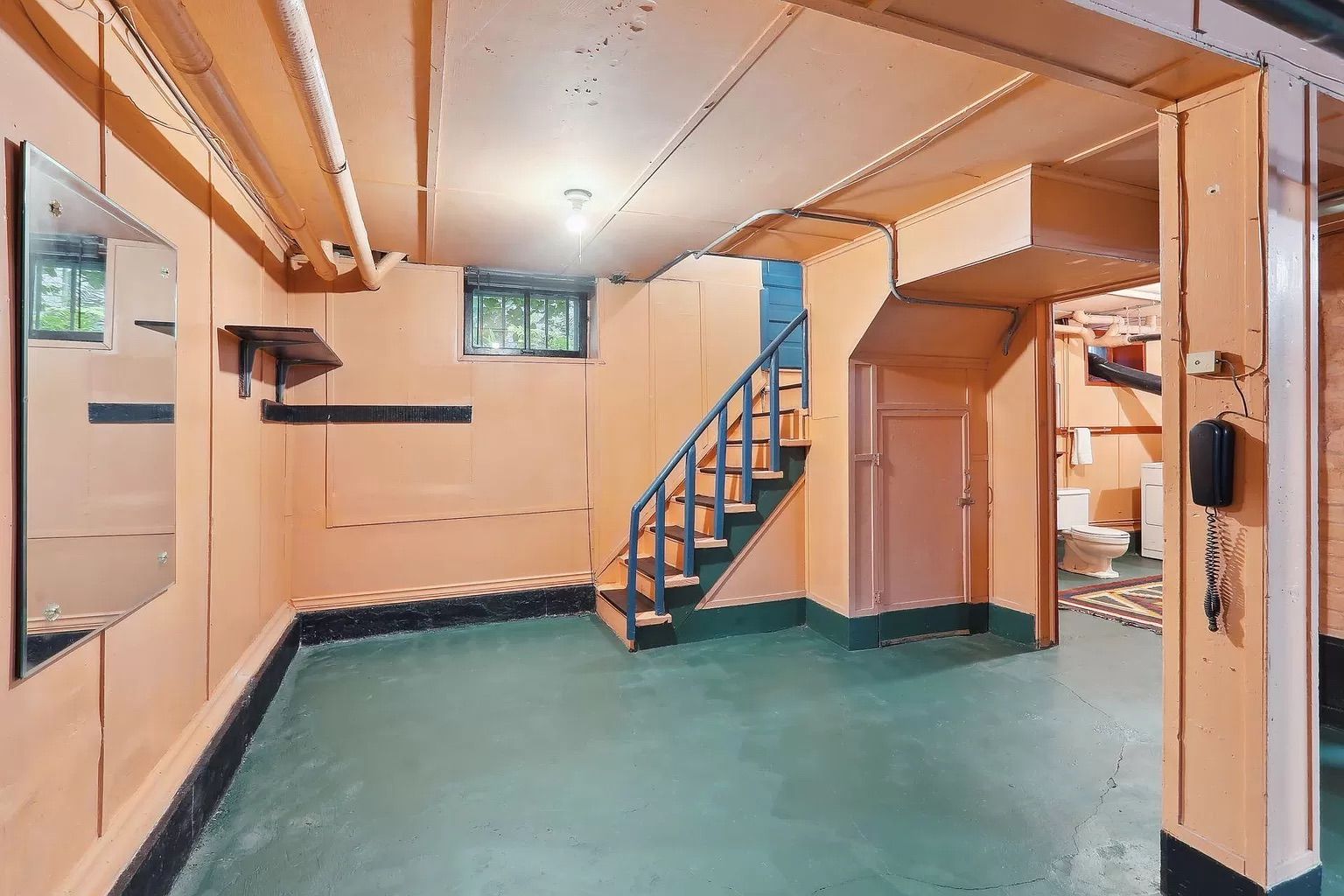 A photo of a peach-colored basement.