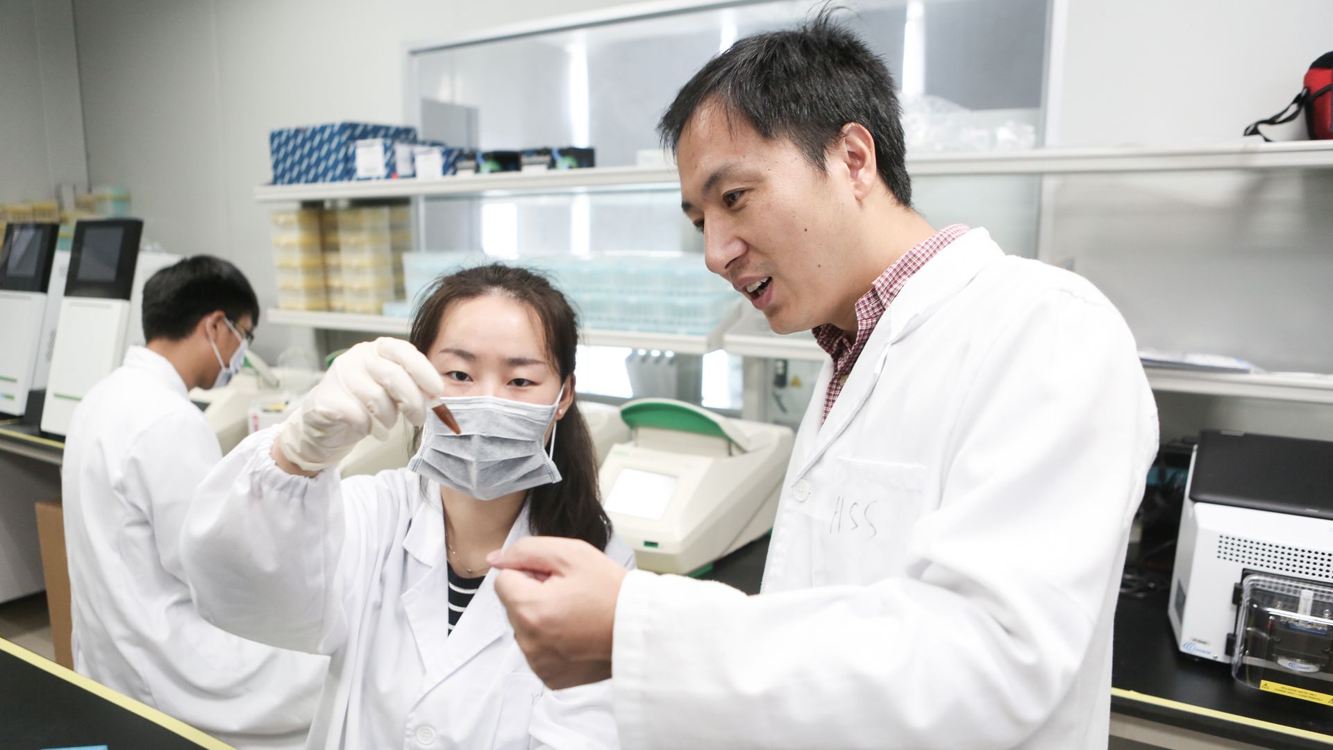 Researcher He Jiankui (R) guides a laboratory staff member at the Direct Genomics lab on August 4, 2016 in Shenzhen, China