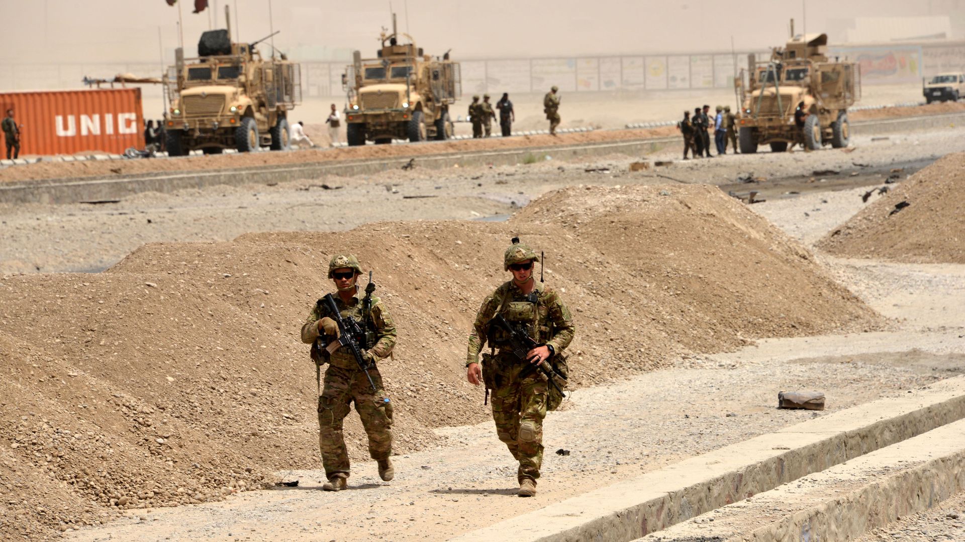 US soldiers walk at the site of a Taliban suicide attack in Kandahar