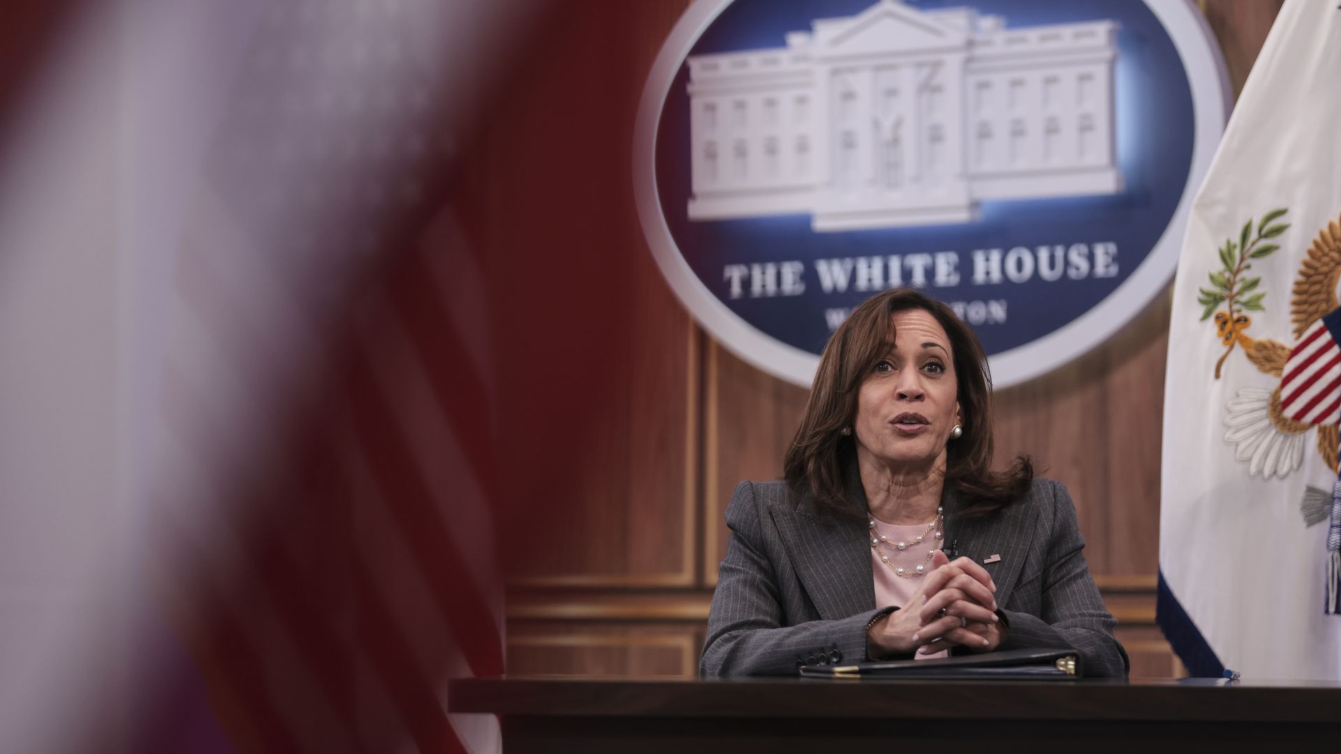 Photo of Kamala Harris sitting at a table with her hands folded in front of her