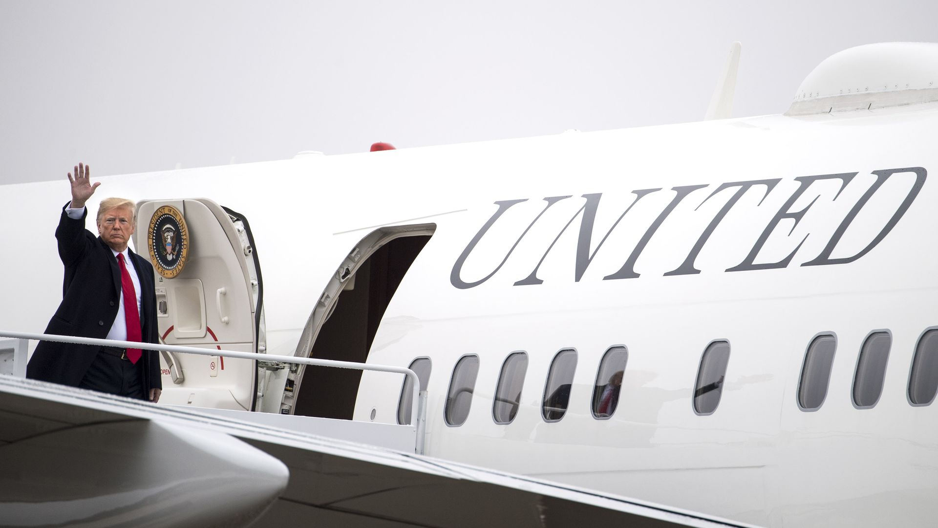Trump waving before entering his plane, Air Force One. 