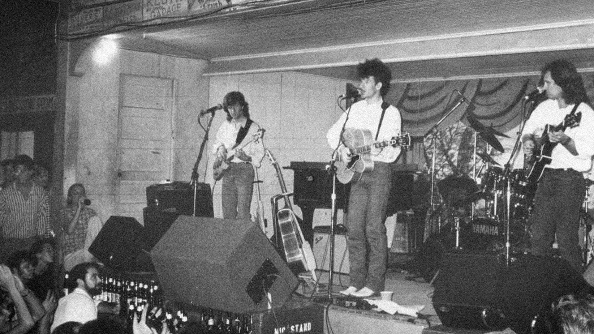 A black-and-white photo of Lyle Lovett and his band performing on stage at Gruene Hall.
