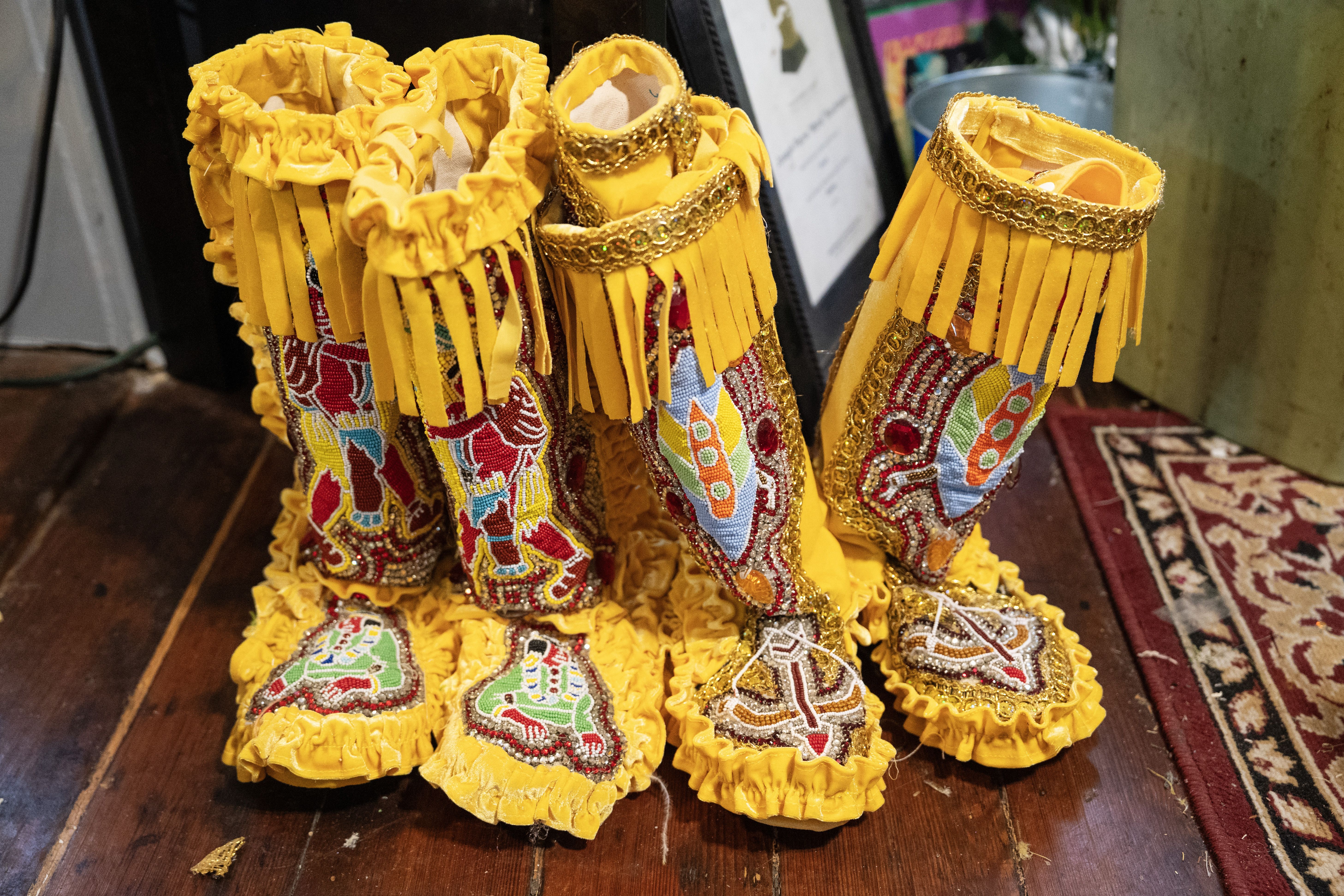 Photo shows a close-up of yellow beaded Mardi Gras Indian boots