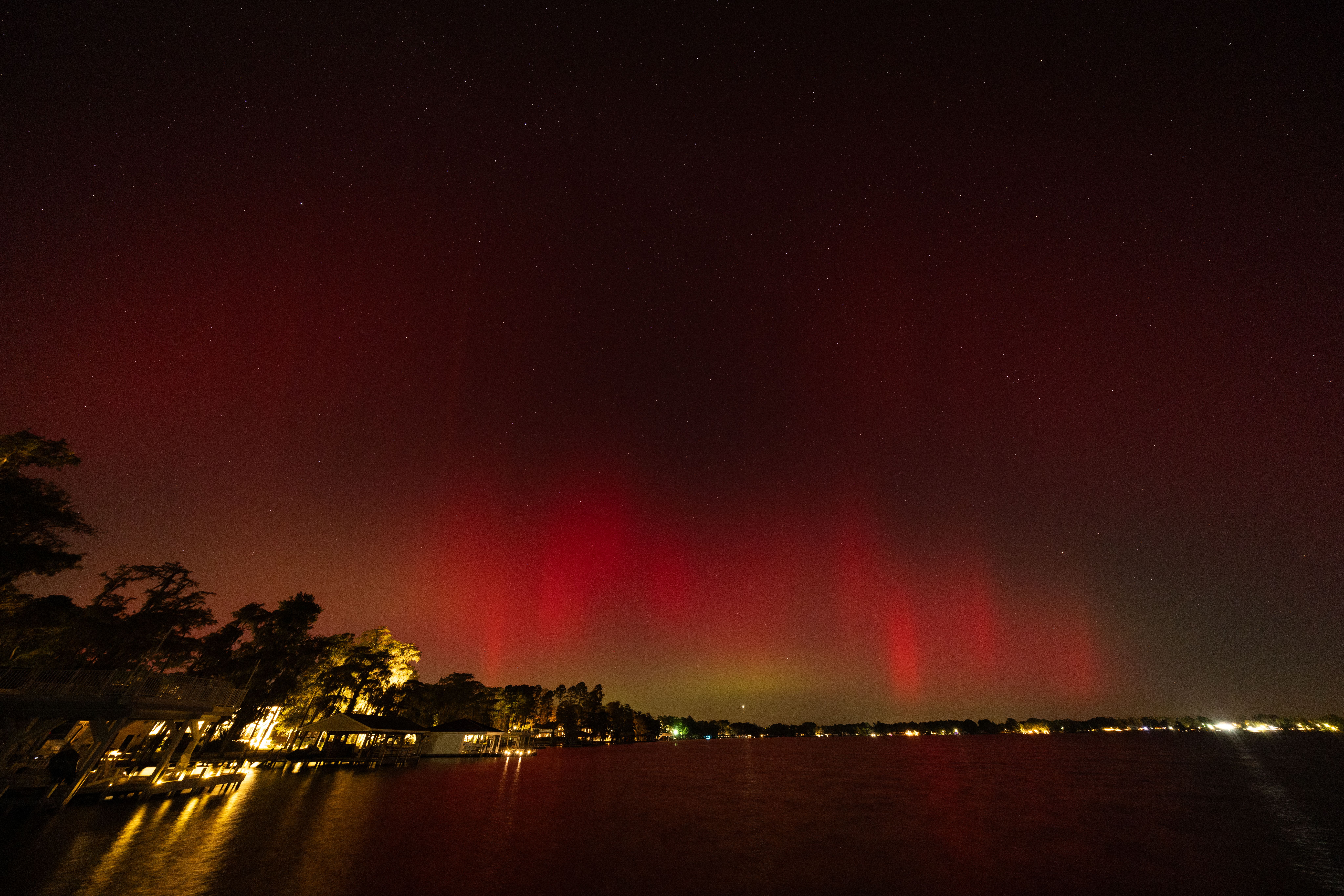 Red and green Northern Lights appear in the sky during a geomagnetic storm on October 10, 2024 in White Lake, North Carolina. 