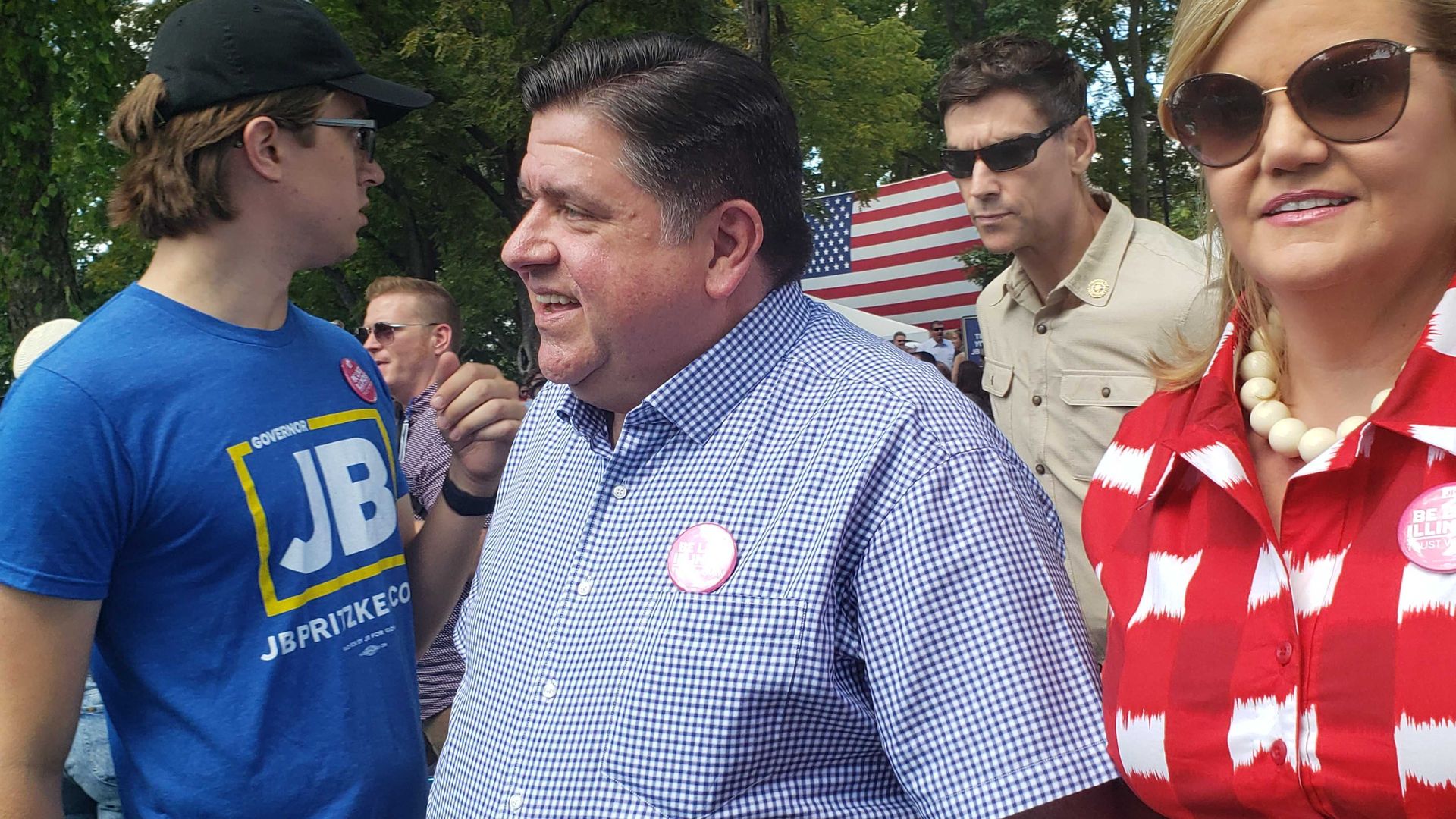 Photo of a man walking through the crowd. 