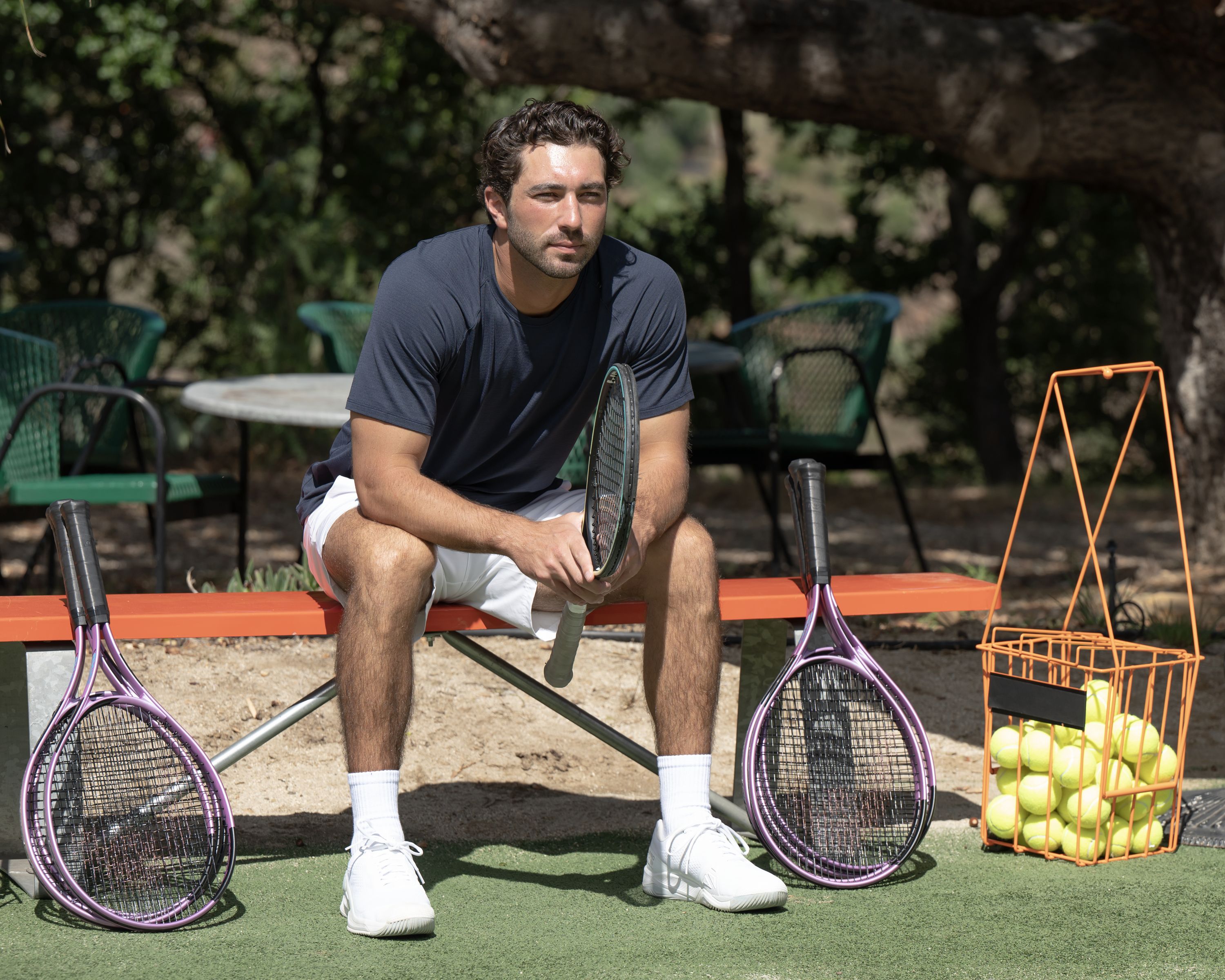 Photo shows Joey from "The Bachelor" holding a tennis racquet.