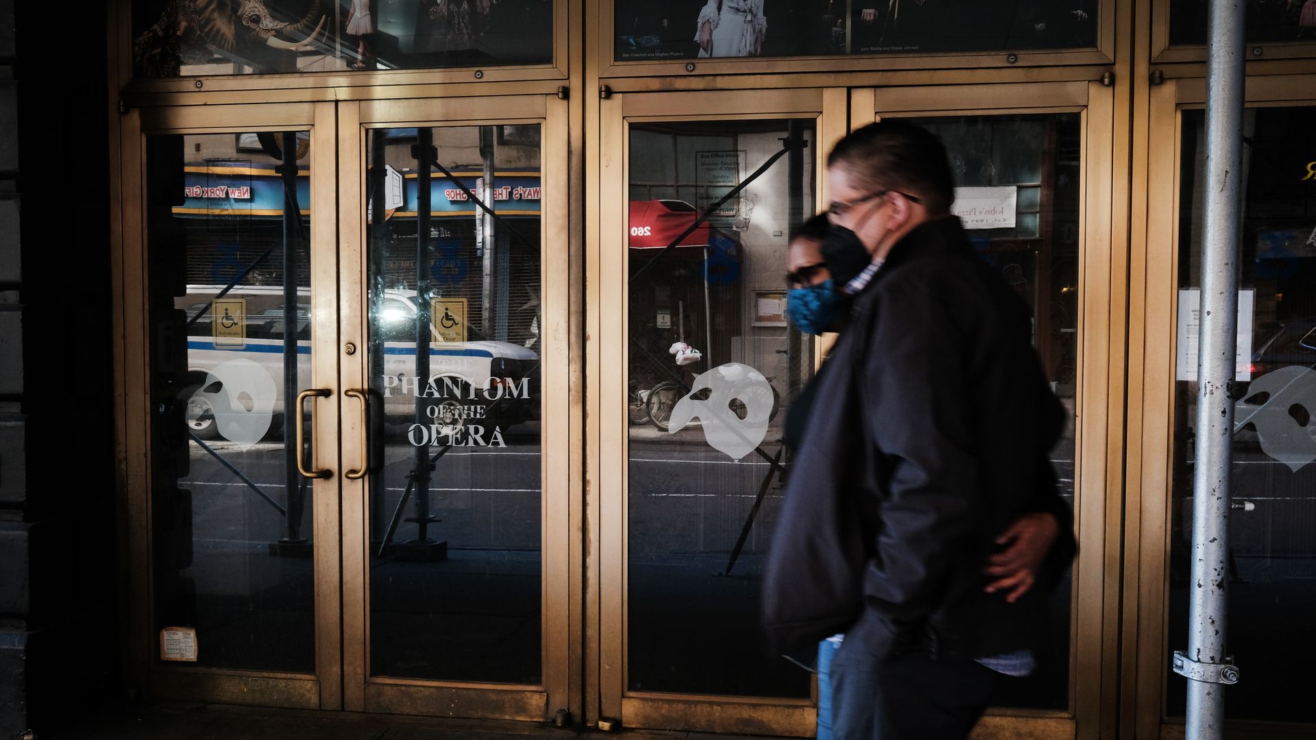 People walk through the empty Broadway theater district one year after it was closed due to Covid-19 restrictions.