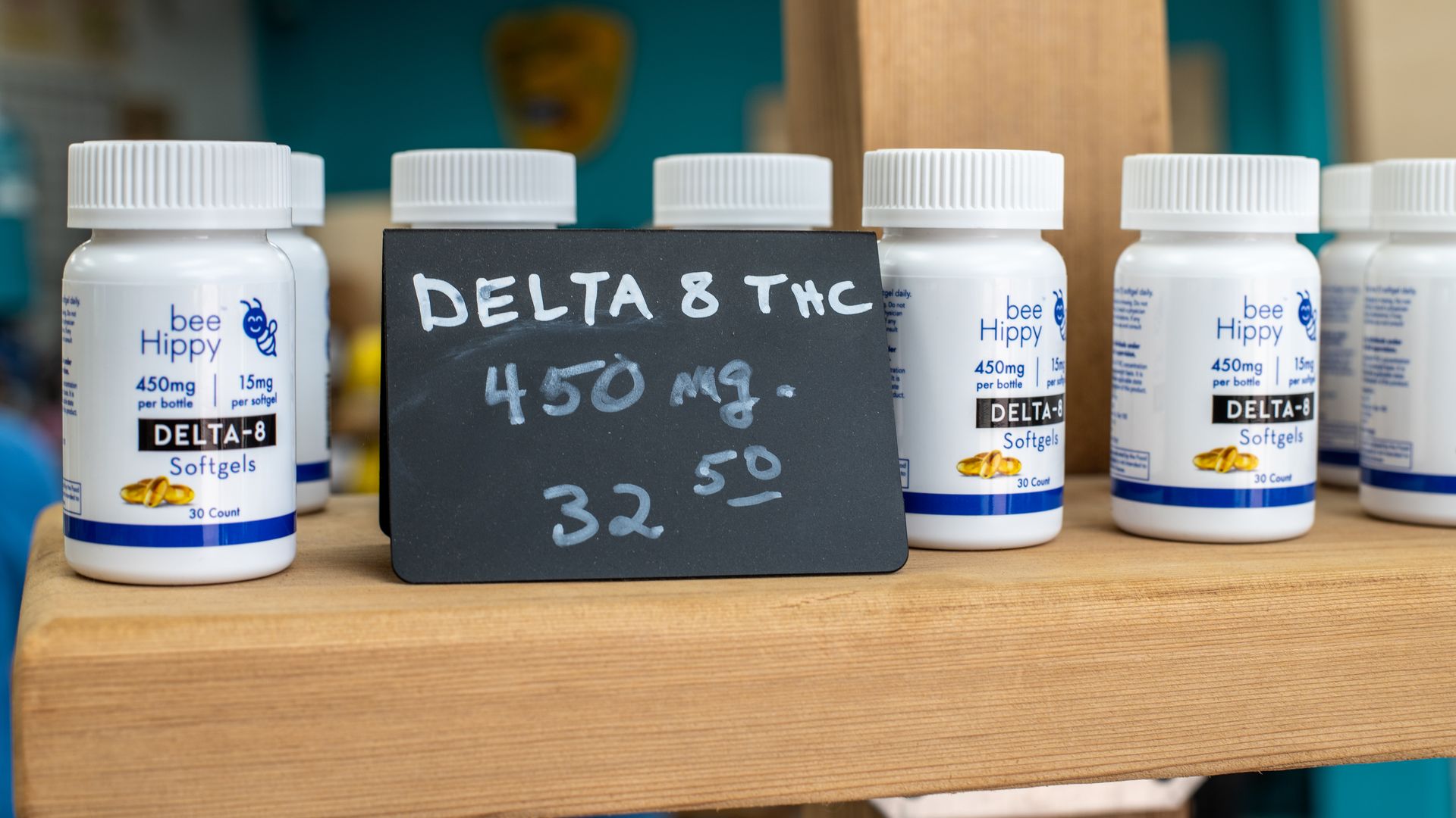 Small white bottles next to a sign that says Delta 8 THC 450mg