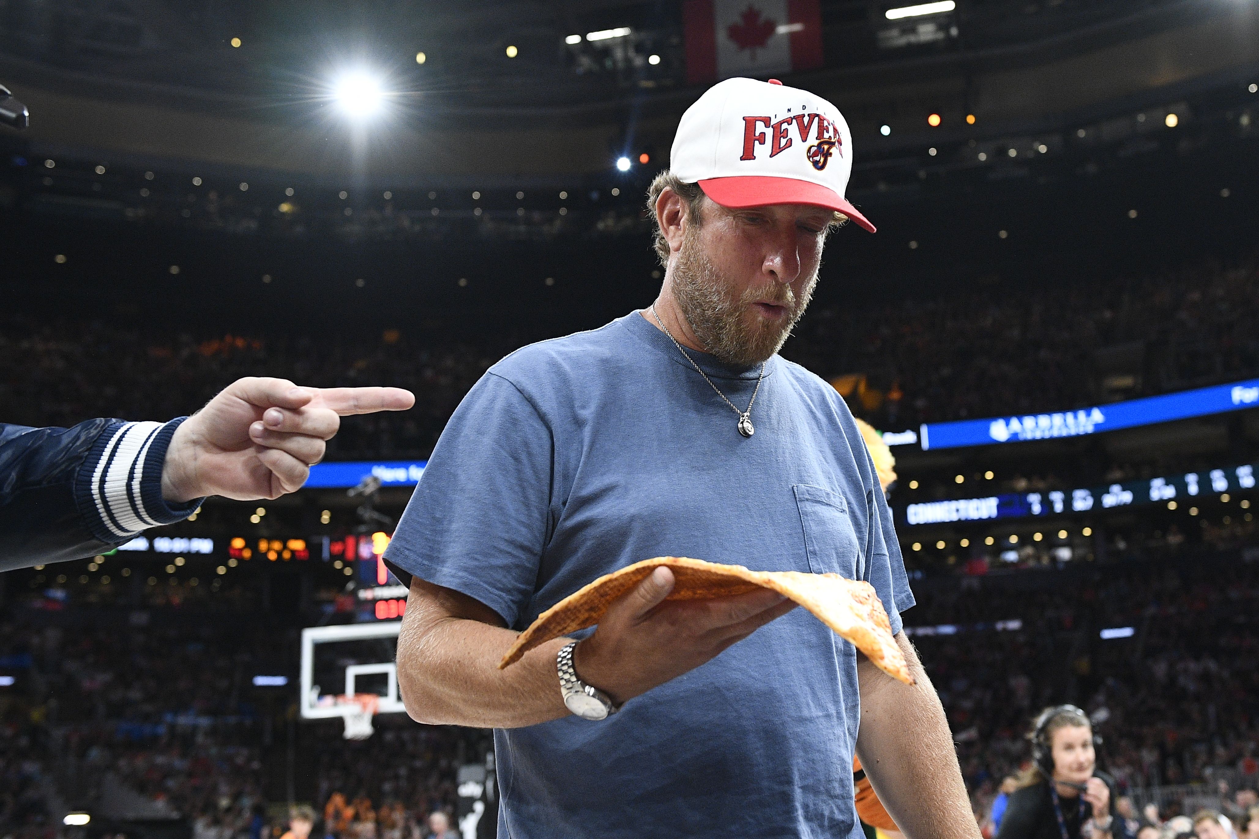 Barstool Sports CEO Dave Portnoy holding a slice of pizza