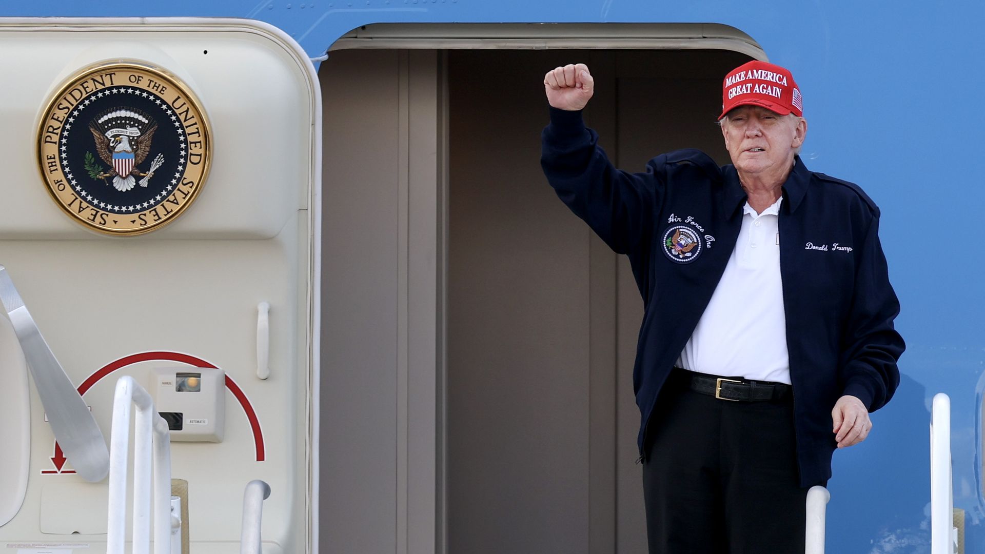 President Donald Trump gestures as he departs Air Force One at Miami International Airport on February 19, 2025 in Miami, Florida. 