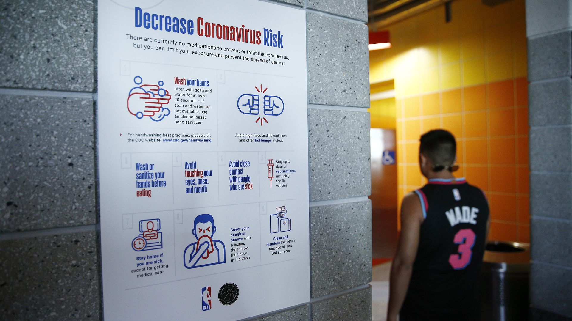 A detailed view of a coronavirus poster outside men's restroom prior to the game between the Miami Heat and the Charlotte Hornets at American Airlines Arena on March 11