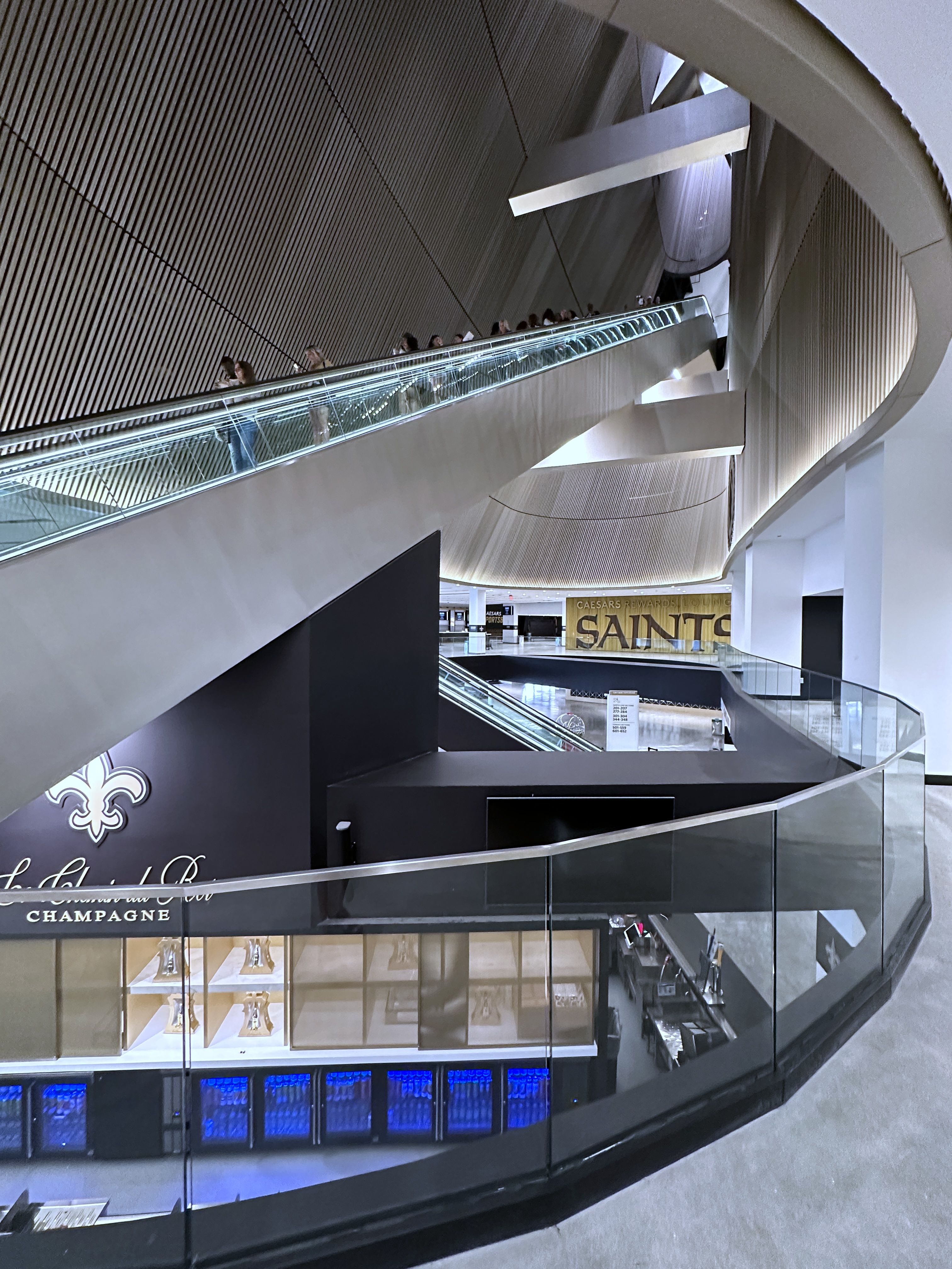 Multiple levels of the Superdome are seen from an atrium as an escalator winds through the space.