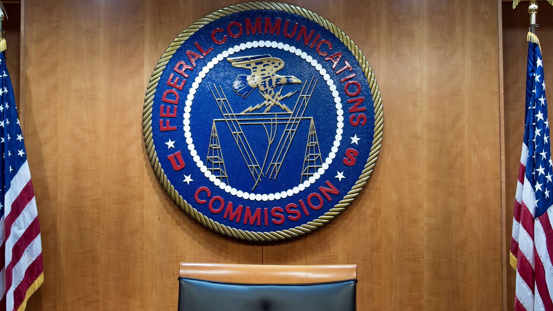 The seal of the FCC mounted on the wall