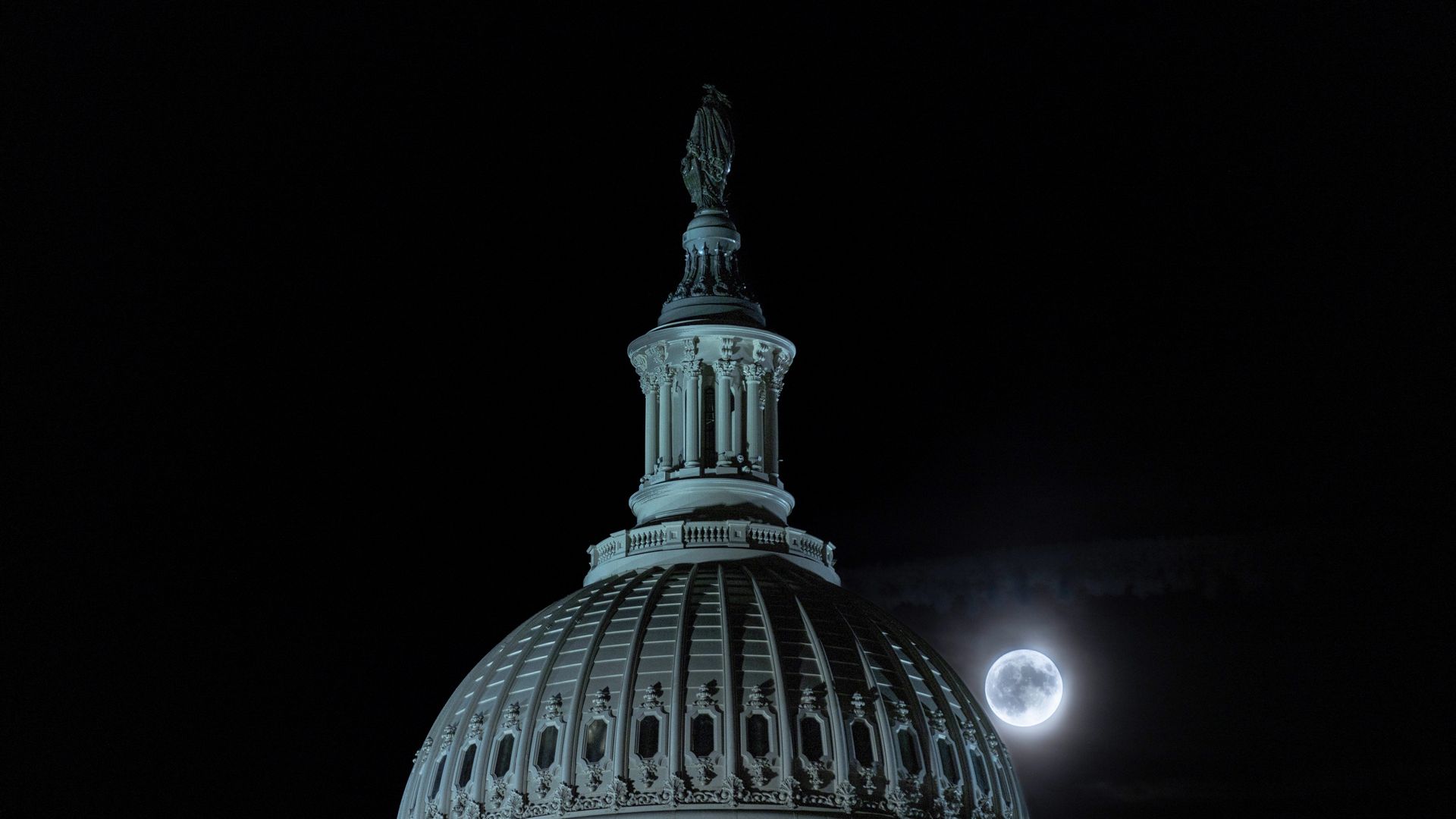 A full moon is seen behind the U.S. Capitol Dome, in Washington, D.C., the United States, Aug. 30, 2023. (Photo by Aaron Schwartz/Xinhua via Getty Images)