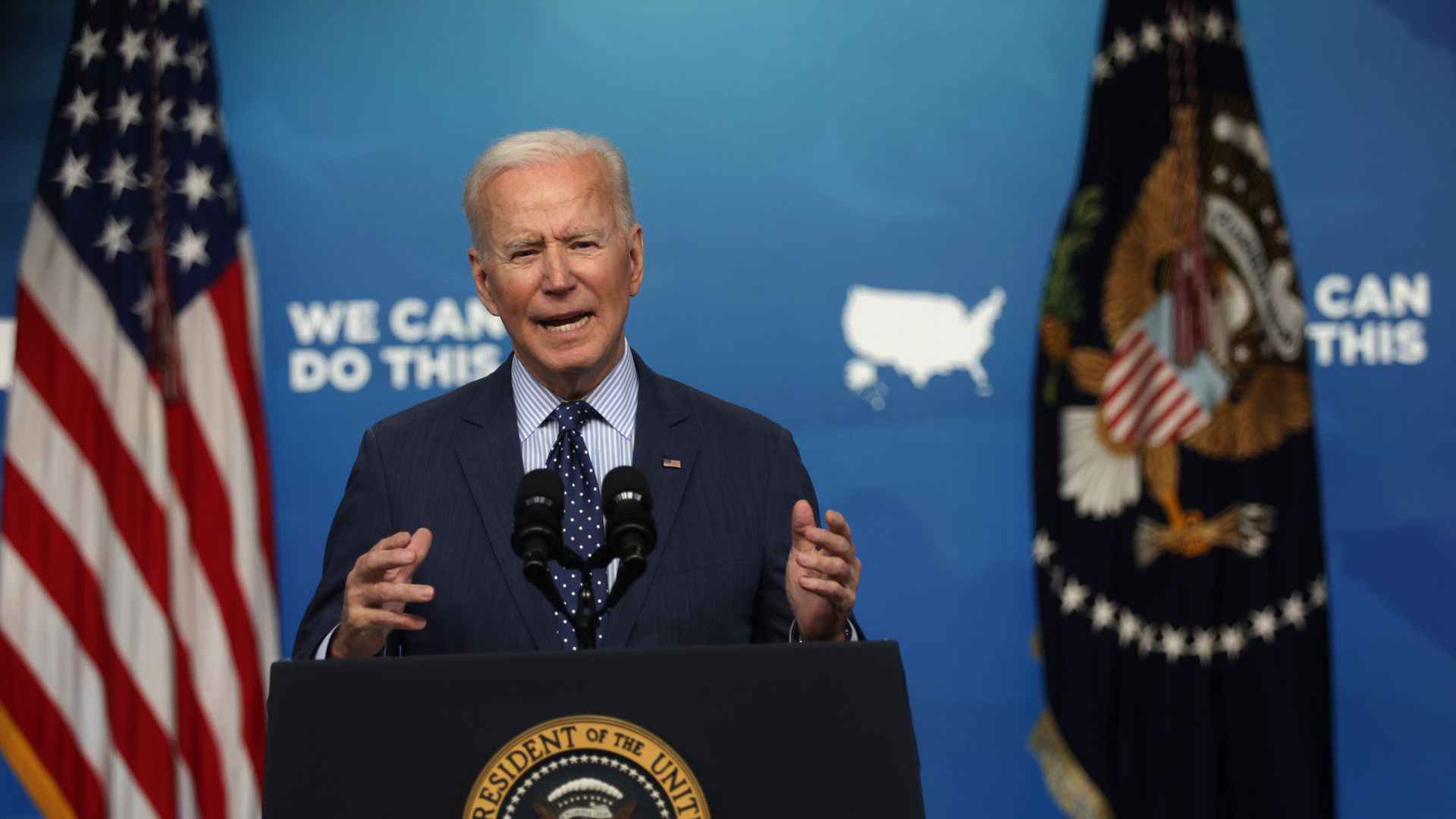 Biden speaks behind a lectern