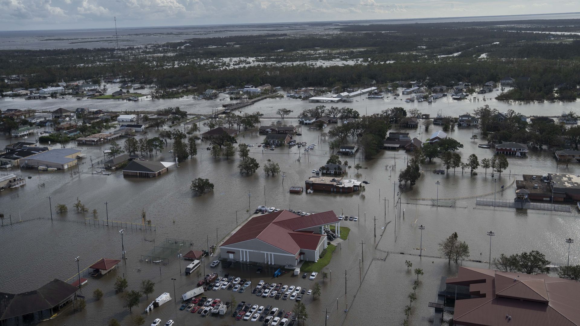 Homes, cars and streets are overwhelmed by water in Lafitte, Louisiana, after Hurricane Ida.