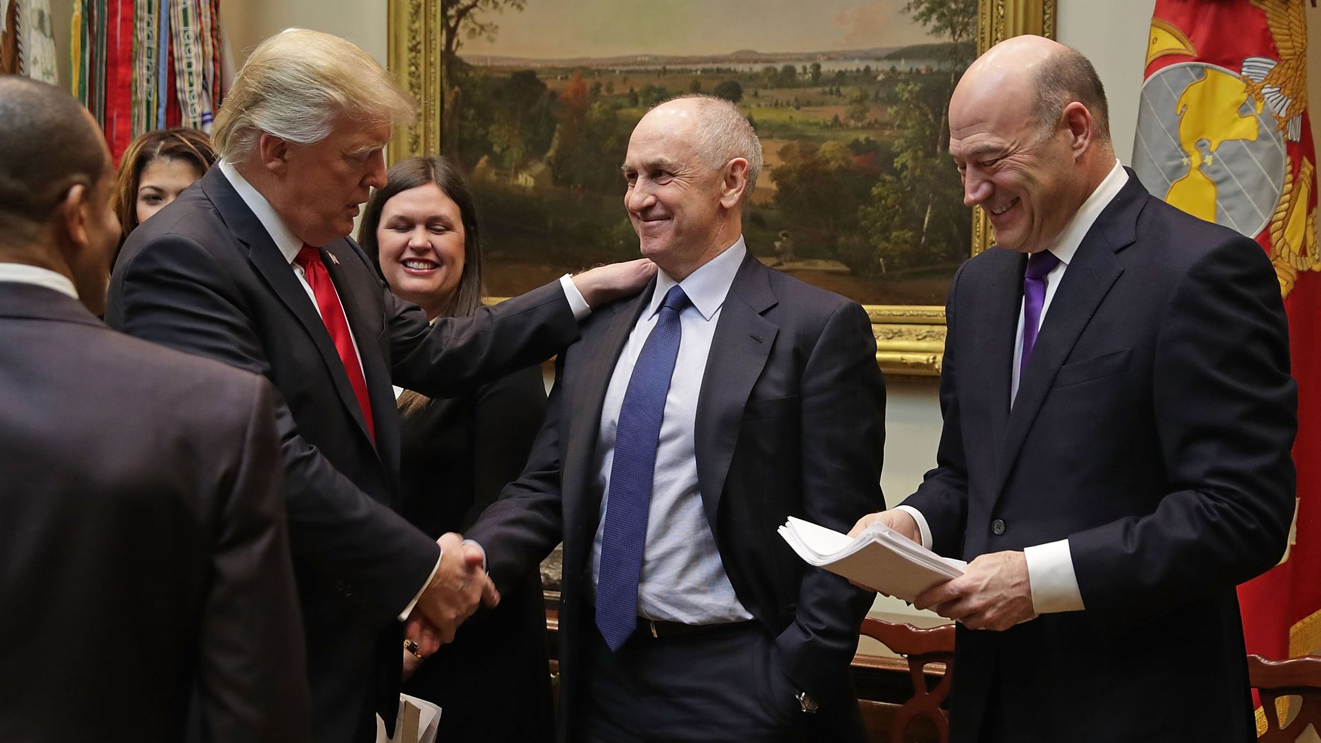 Trump shaking Chris Liddell's hand.