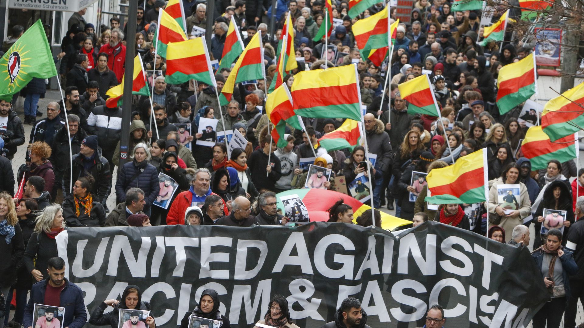 Marchers holding flags and signs