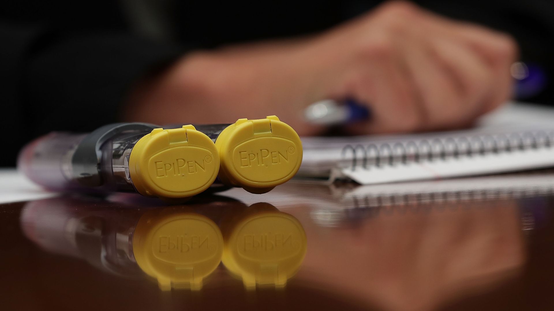 A pair of EpiPen's on a table.