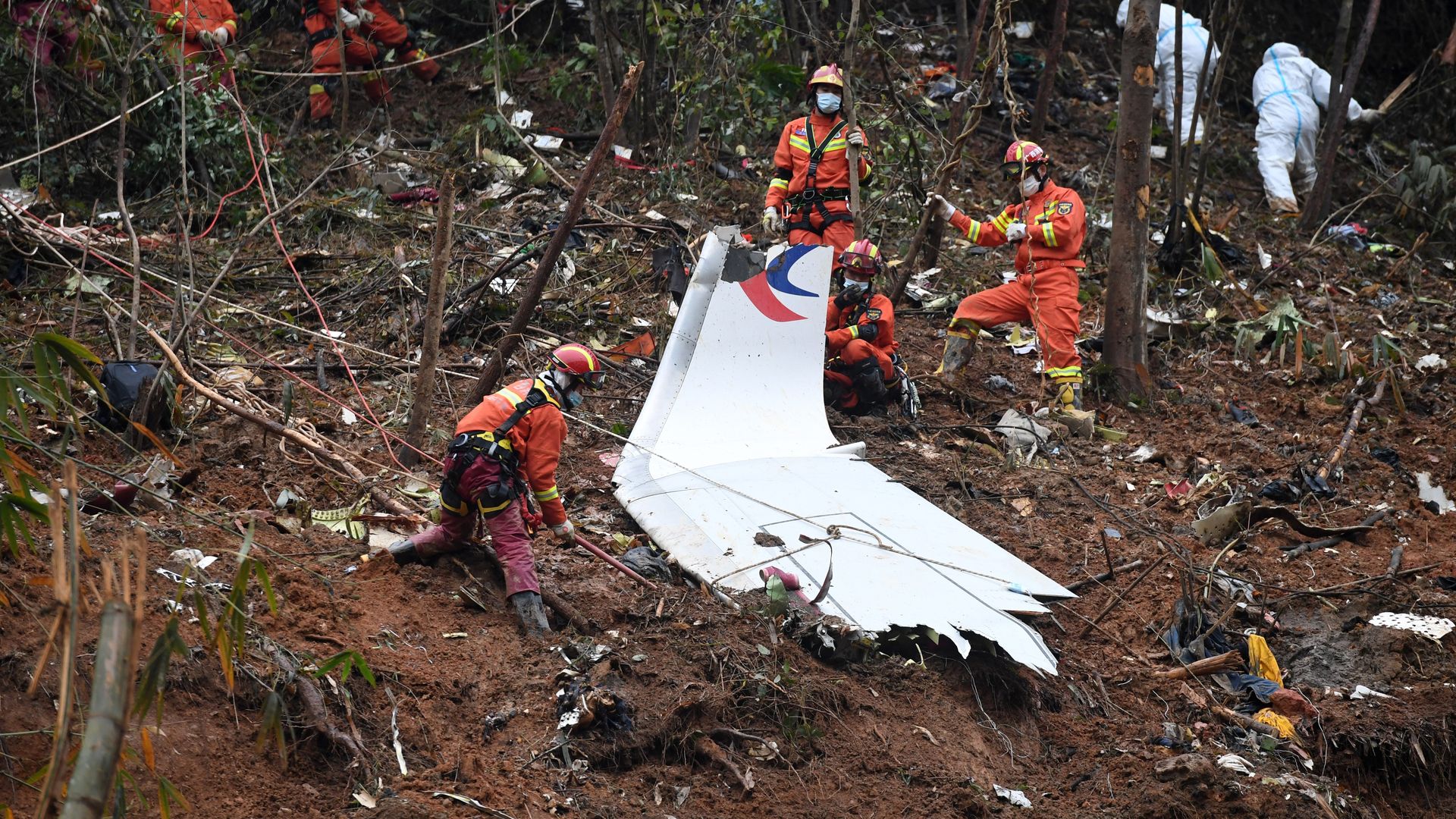Rescuers search for remains in plane crash wreckage in China.