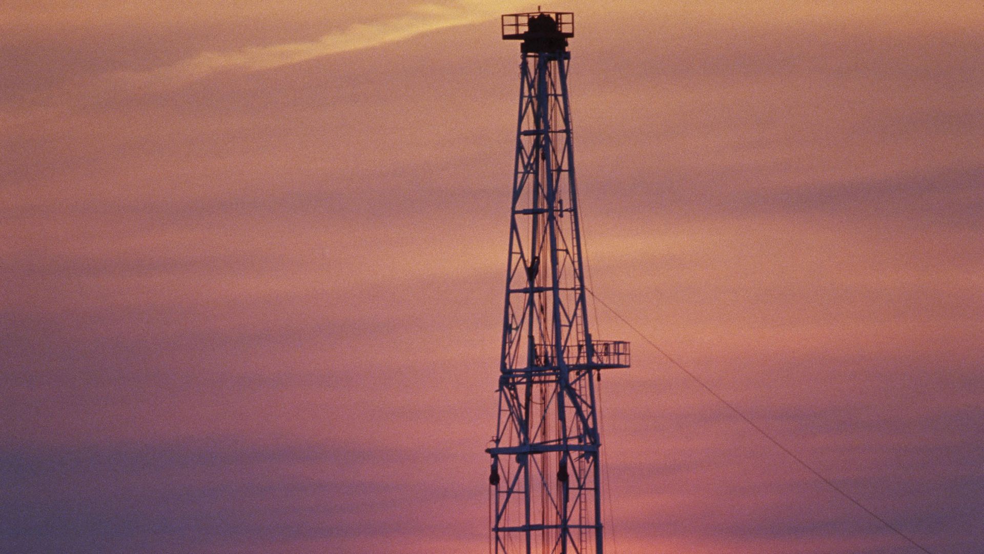 An oil well at sunset is silhouetted at sunset outside Jeddah, Saudi Arabia. 