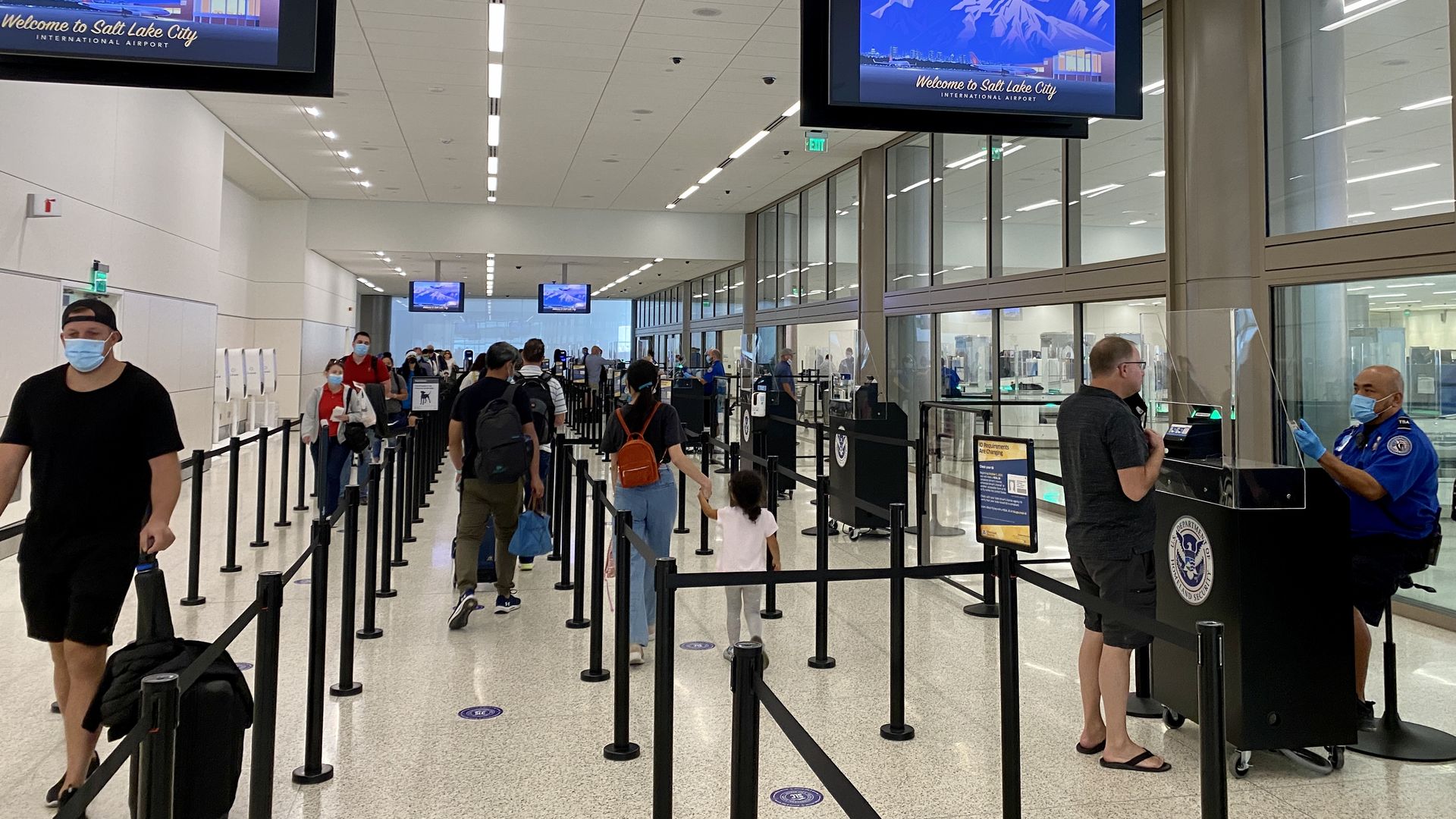 Picture of a TSA officer screening a passenger in Utah