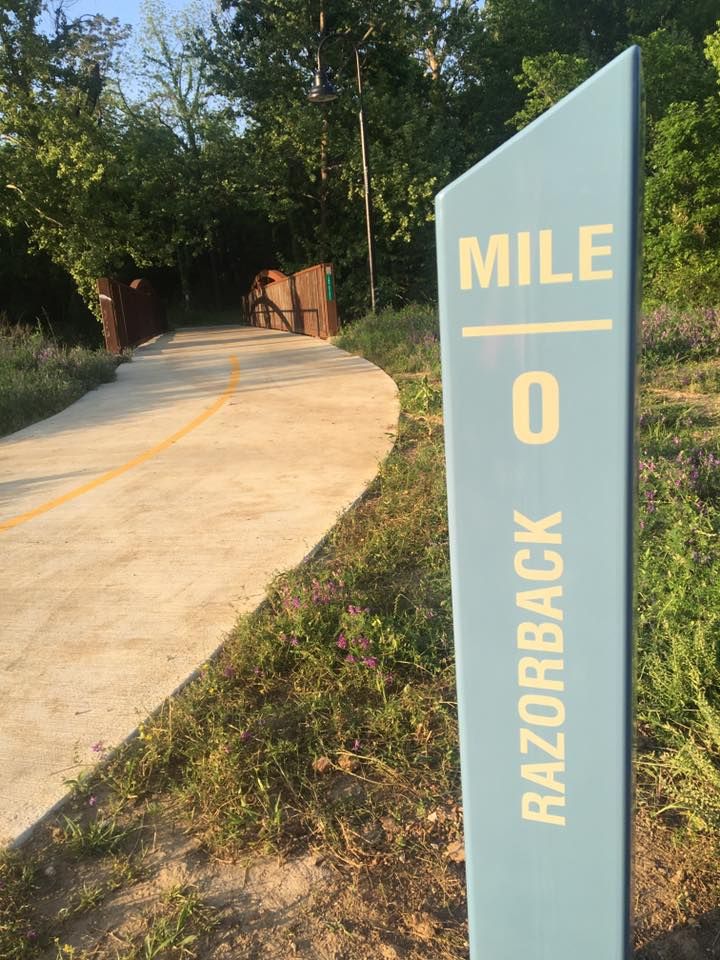A photo of mile marker 0 on the Razorback Greenway. 