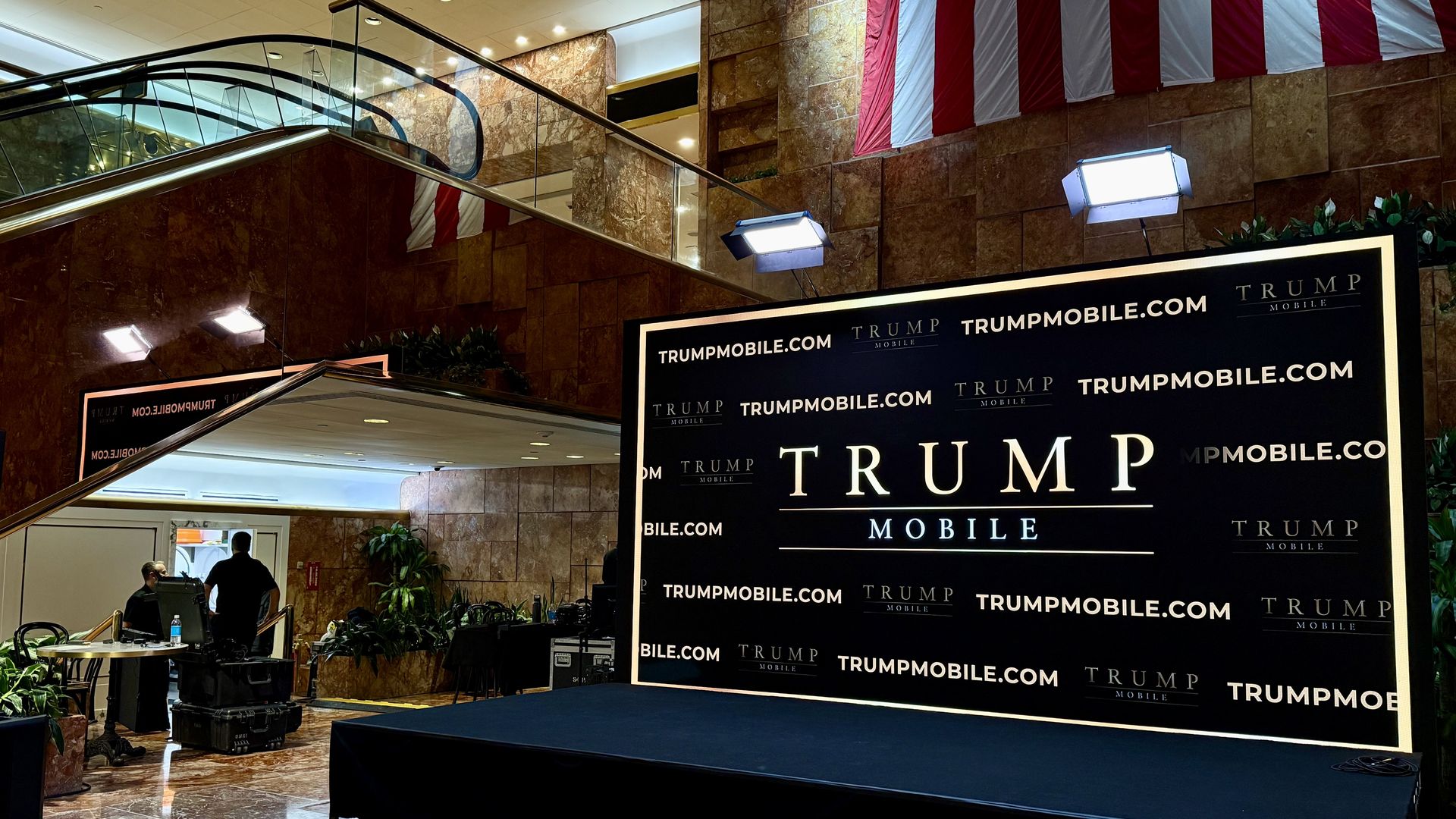 A backdrop reads "Trump Mobile" inside the Trump tower 
