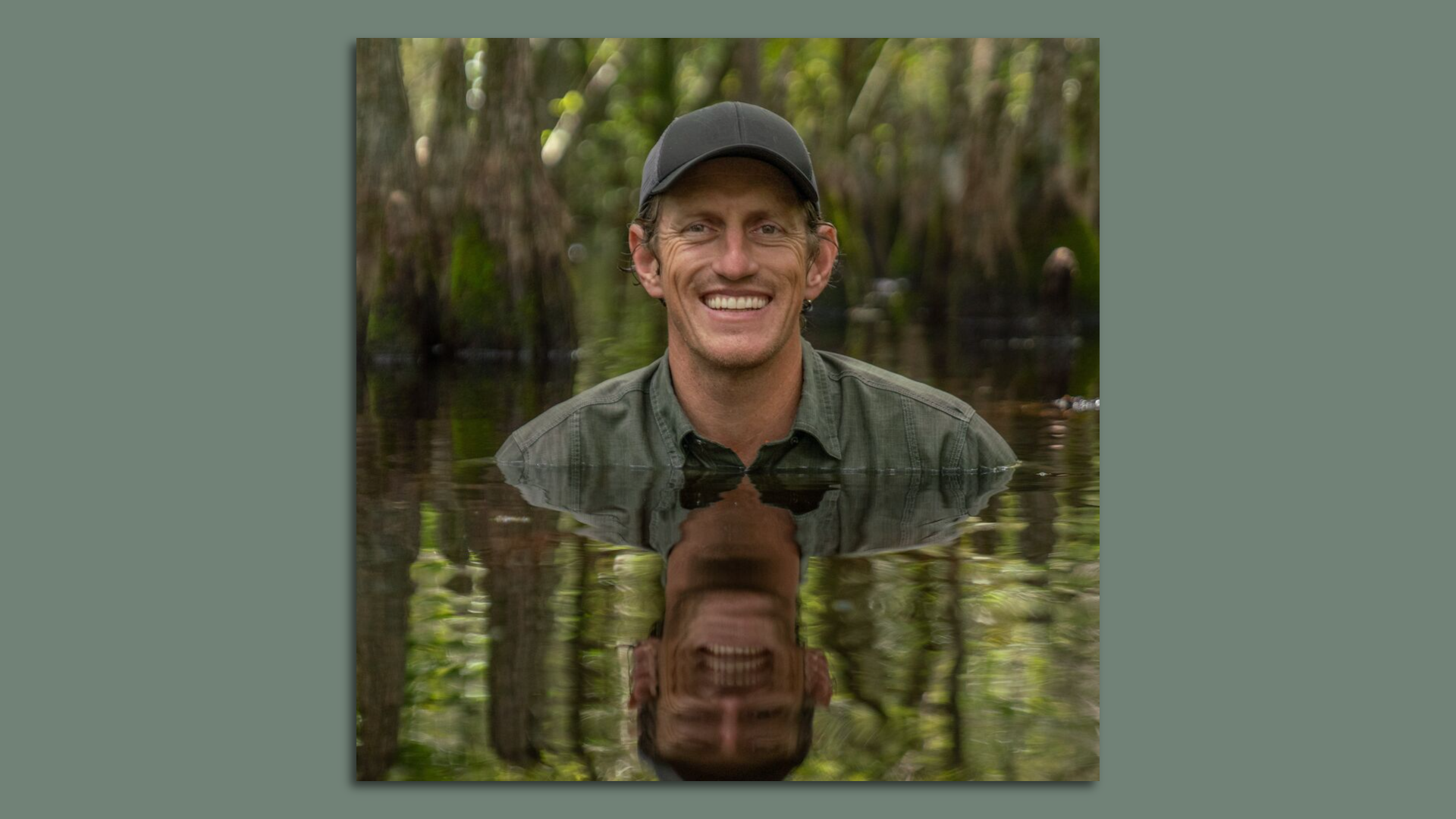Florida wildlife photographer Carlton Ward Jr. smiles while posing submerged in a swamp.