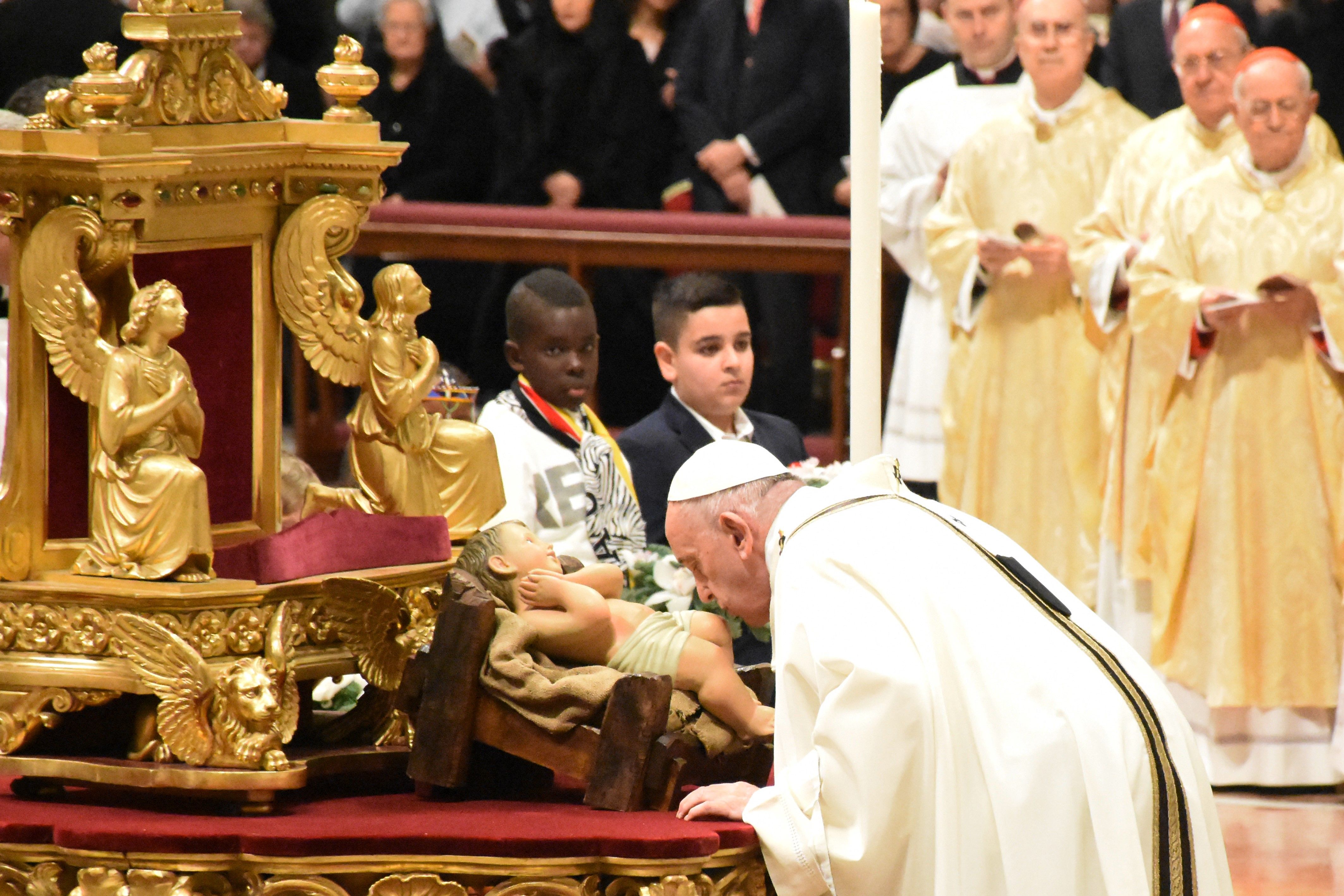 Pope Francis (R) leads a mass on Christmas eve marking the birth of Jesus Christ on December 24